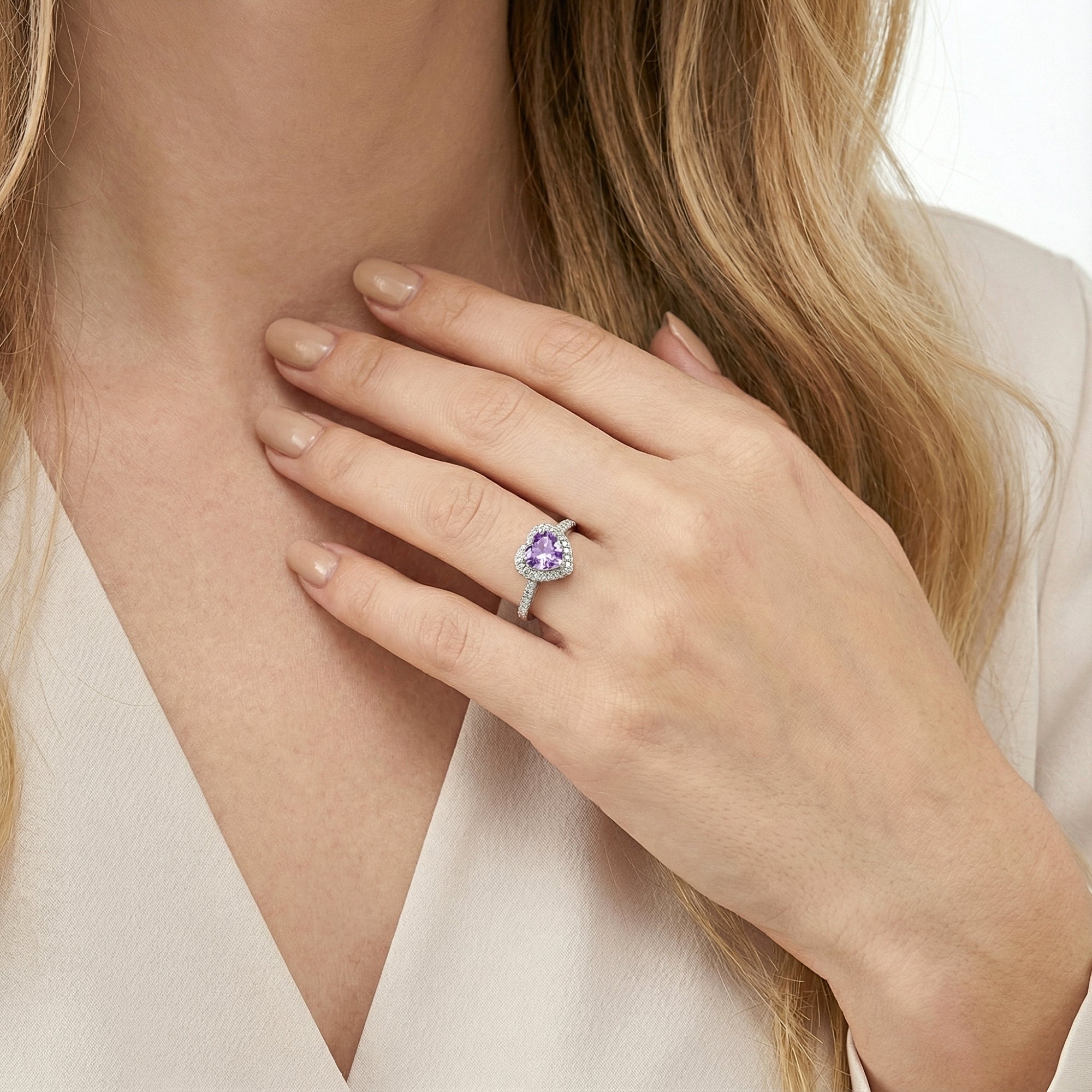 Heart-cut purple amethyst halo ring in S925 sterling silver shown on a model's hand for scale.