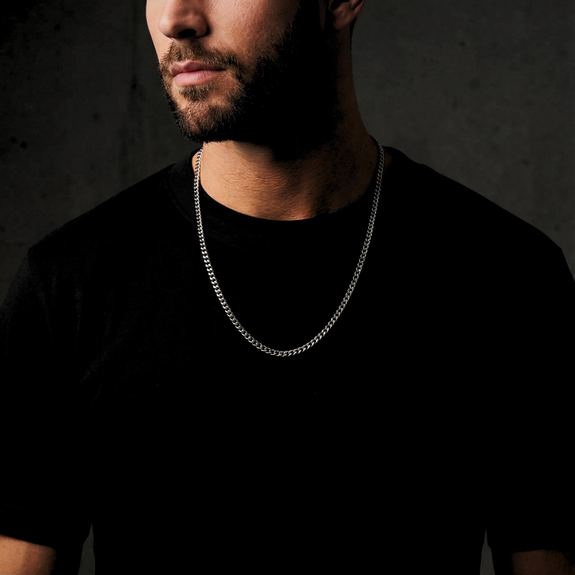 A model wearing the waterproof 4mm silver Miami Cuban chain over a black t-shirt for a bold look.