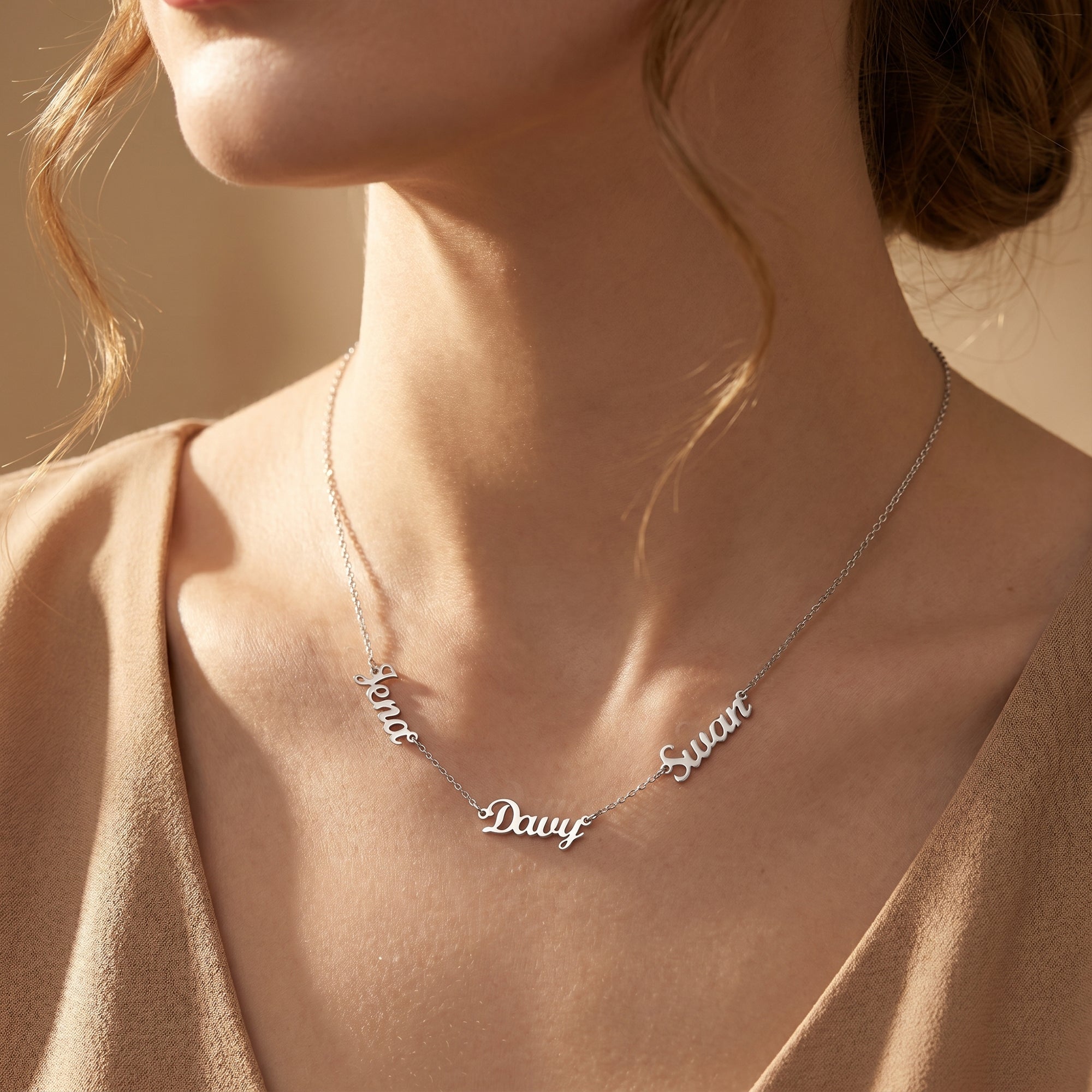 Model wearing the silver PVD stainless steel Penelope name necklace.