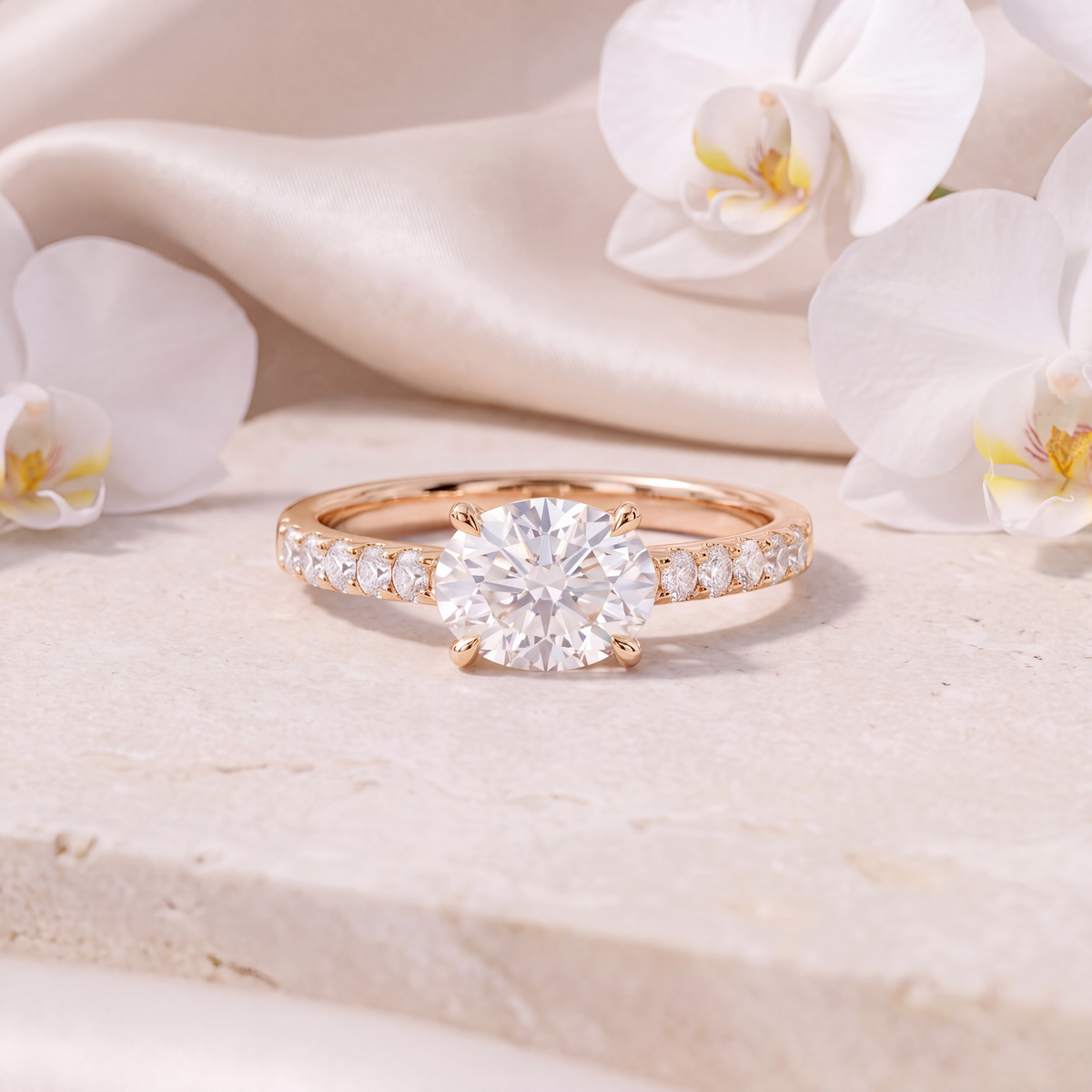 Front view of a rose gold moissanite engagement ring with a round center stone and pave band.