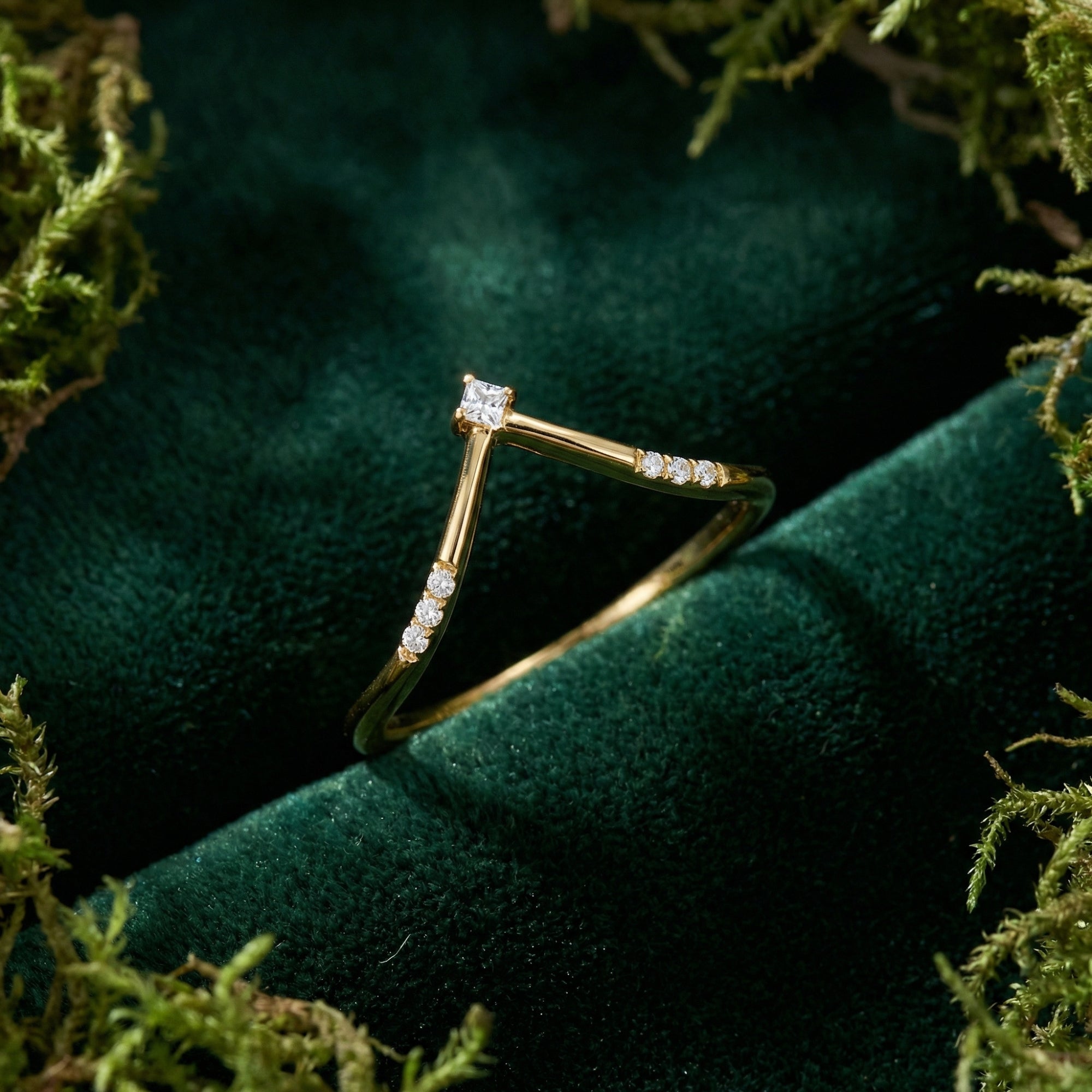 Detail shot of the gold-plated sterling silver chevron accent ring with small diamond-like stones on velvet.