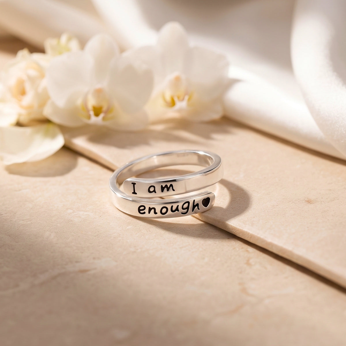 Silver open wrap ring showing both I am enough engraving bands