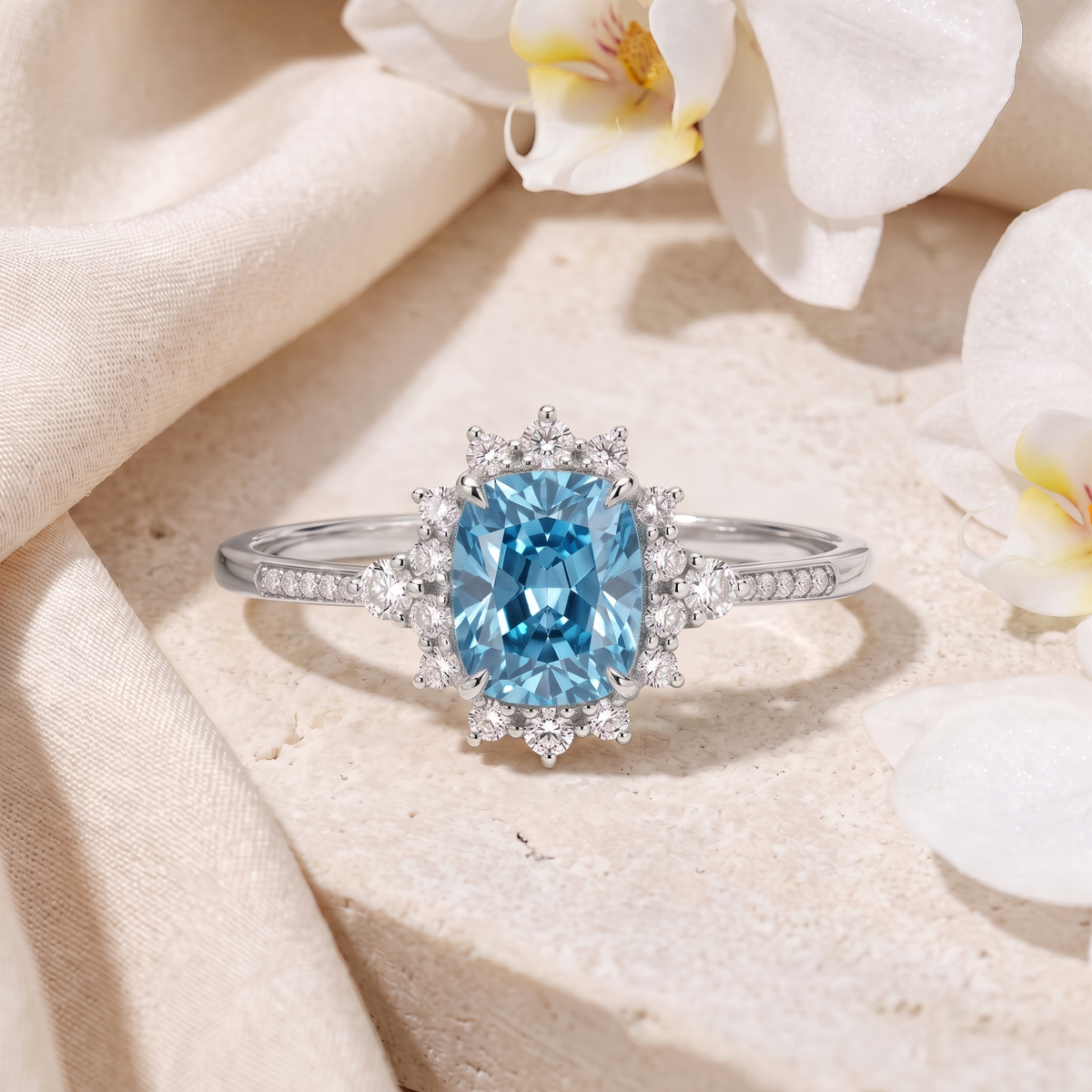 Front view of the white gold halo ring set with a cushion-cut blue gemstone.