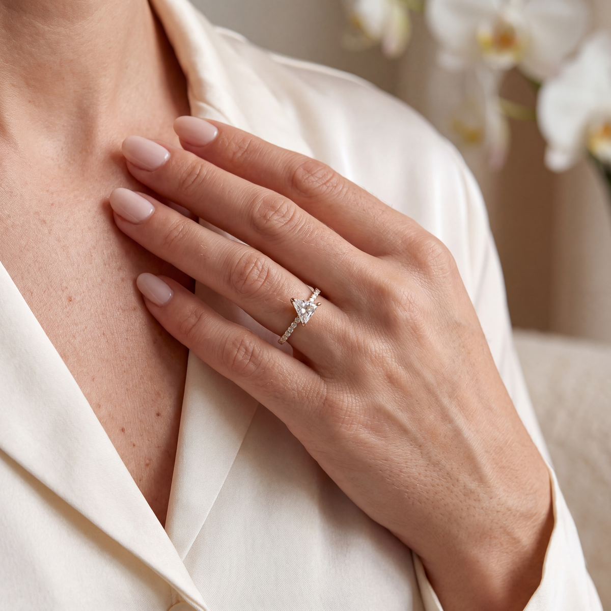 Model wearing the yellow gold trillion-cut moissanite ring on her hand.