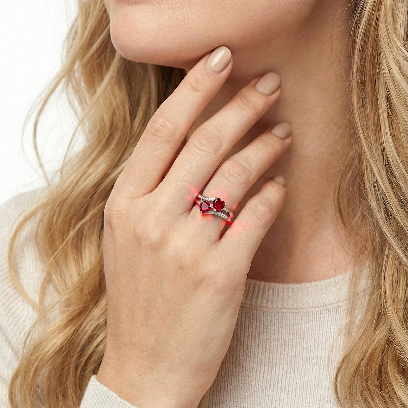 Close-up of a model's hand wearing the Elianara sterling silver ring with two heart-cut simulated rubies.