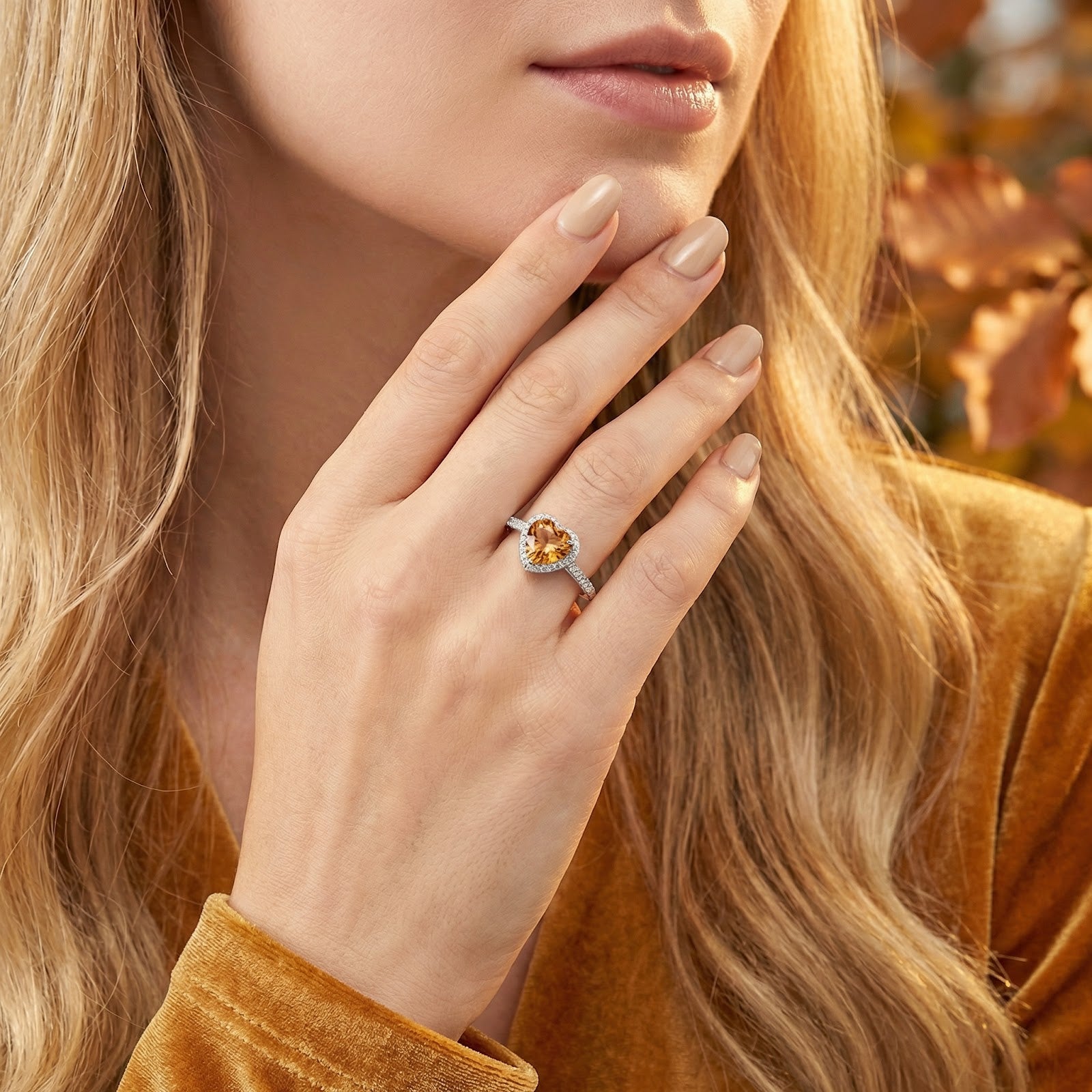 Model wearing the Maridelle heart halo ring in S925 sterling silver with a golden simulated topaz stone.