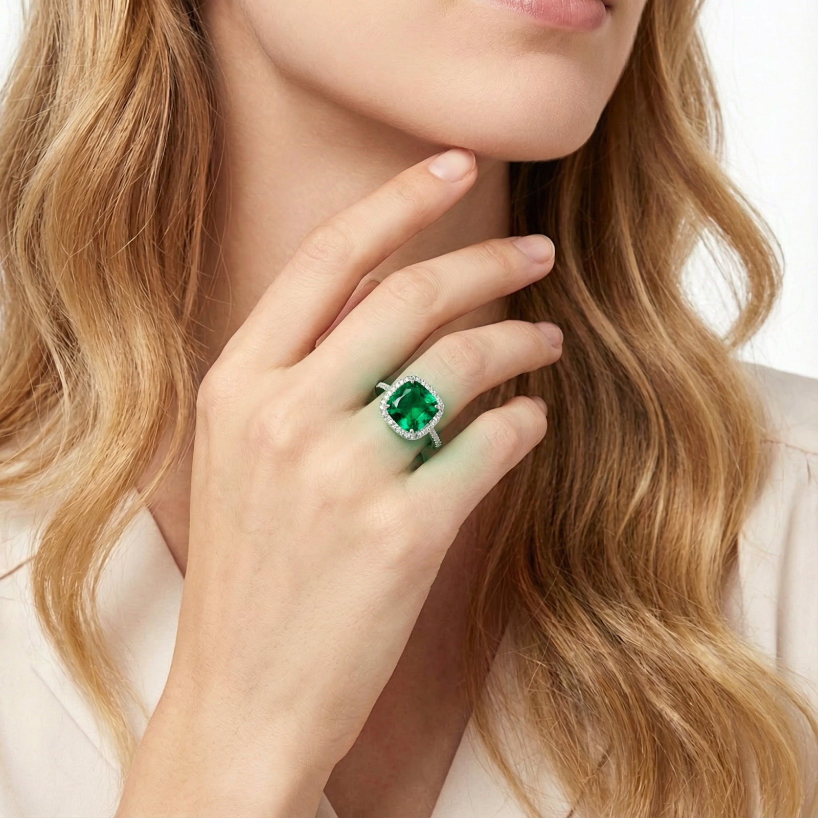 Sterling silver cushion-cut simulated emerald halo ring shown on a model's hand.
