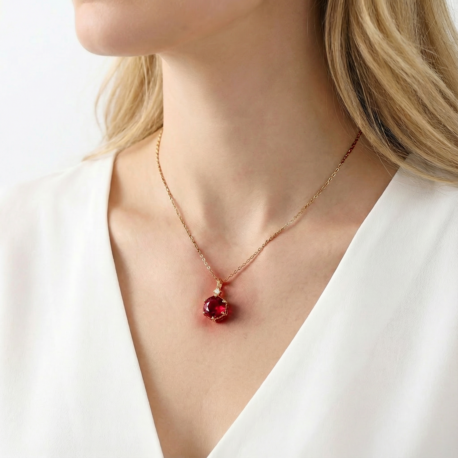 Side profile of a model wearing the hexagonal 18K gold vermeil necklace with a red ruby.