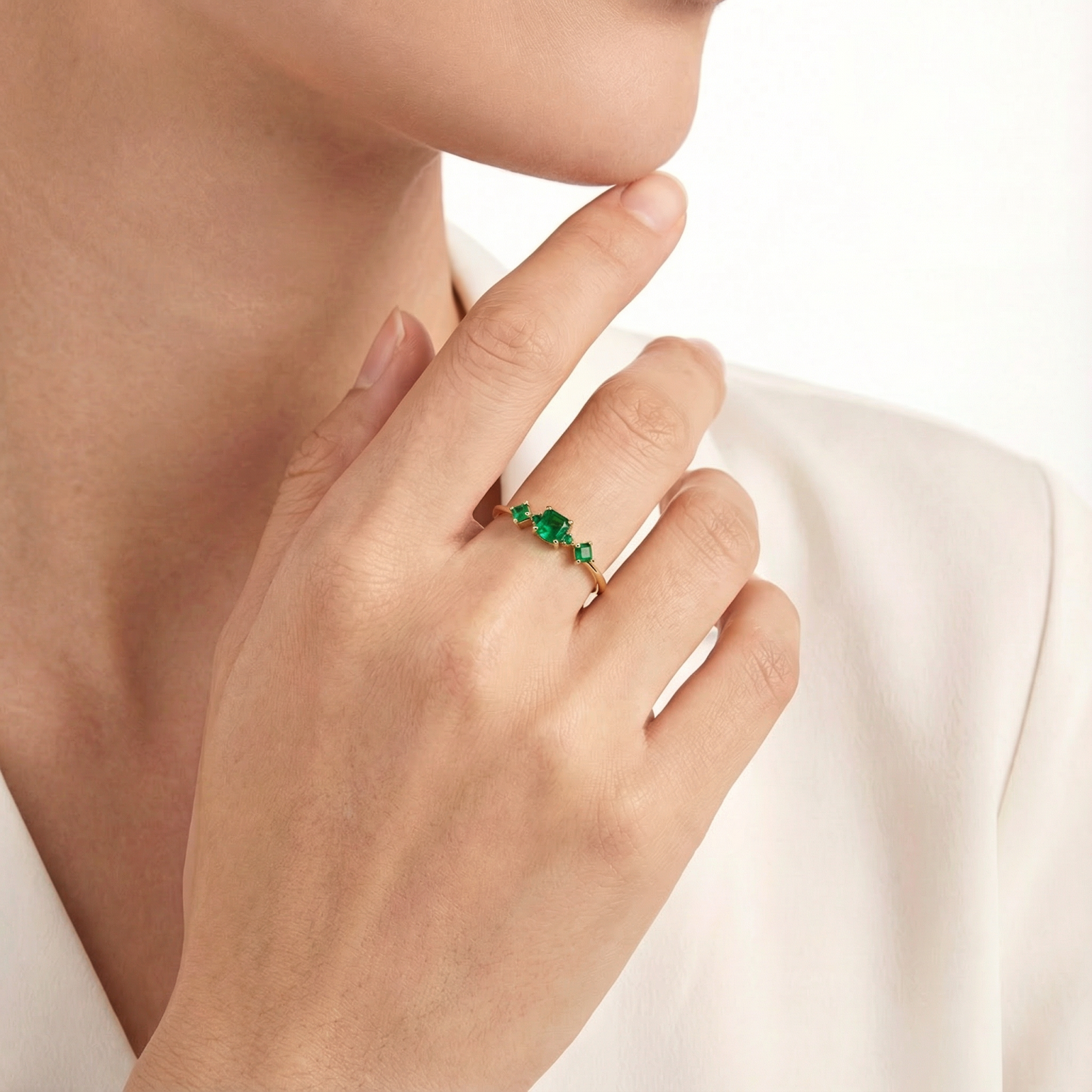 Eldora gold vermeil simulated emerald ring worn on a model's hand, showcasing the multi-stone cluster design.