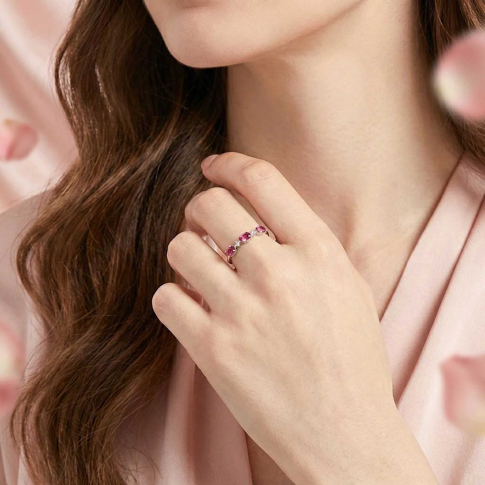 Model wearing the Aurelissa S925 sterling silver bypass ring with vivid pink tourmaline stones on her finger.