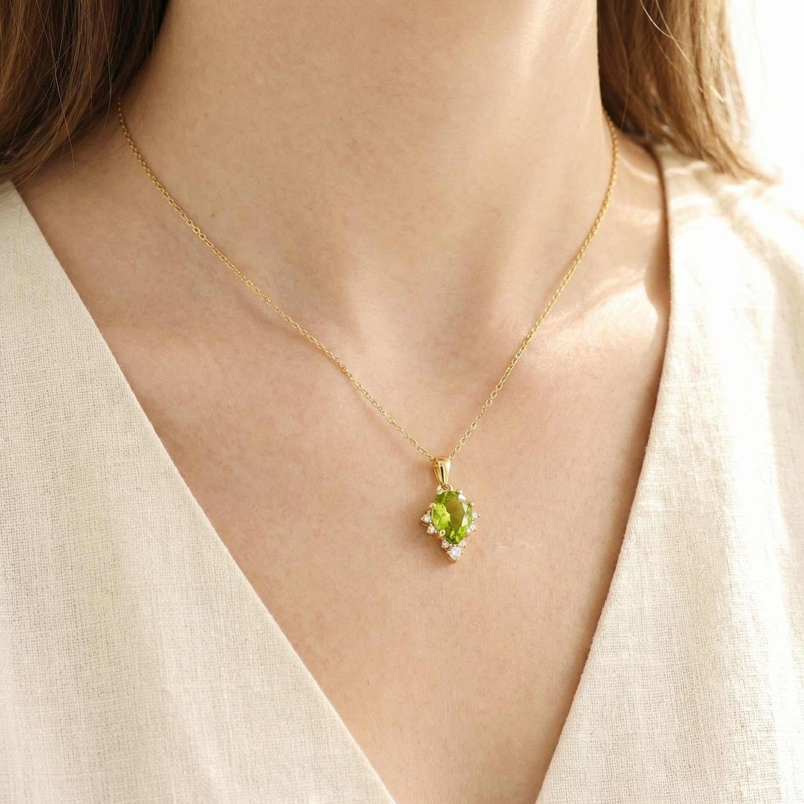 Close-up of a model wearing the teardrop simulated peridot necklace in 18K gold vermeil on a delicate chain.