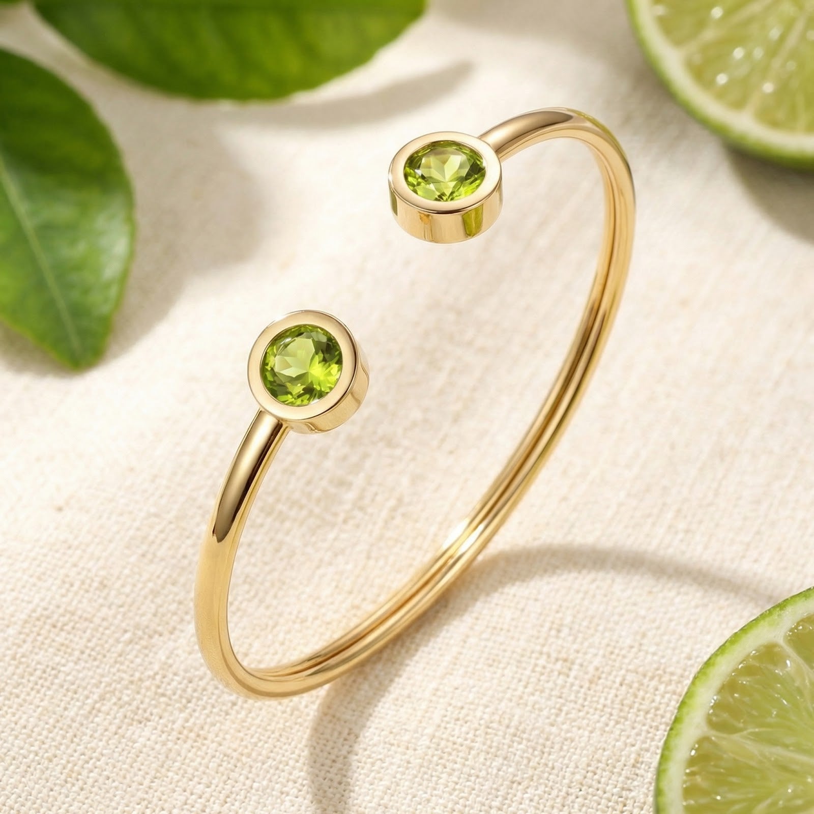 Gold stainless steel Peridara cuff bracelet with round simulated peridots on a styled citrus background.