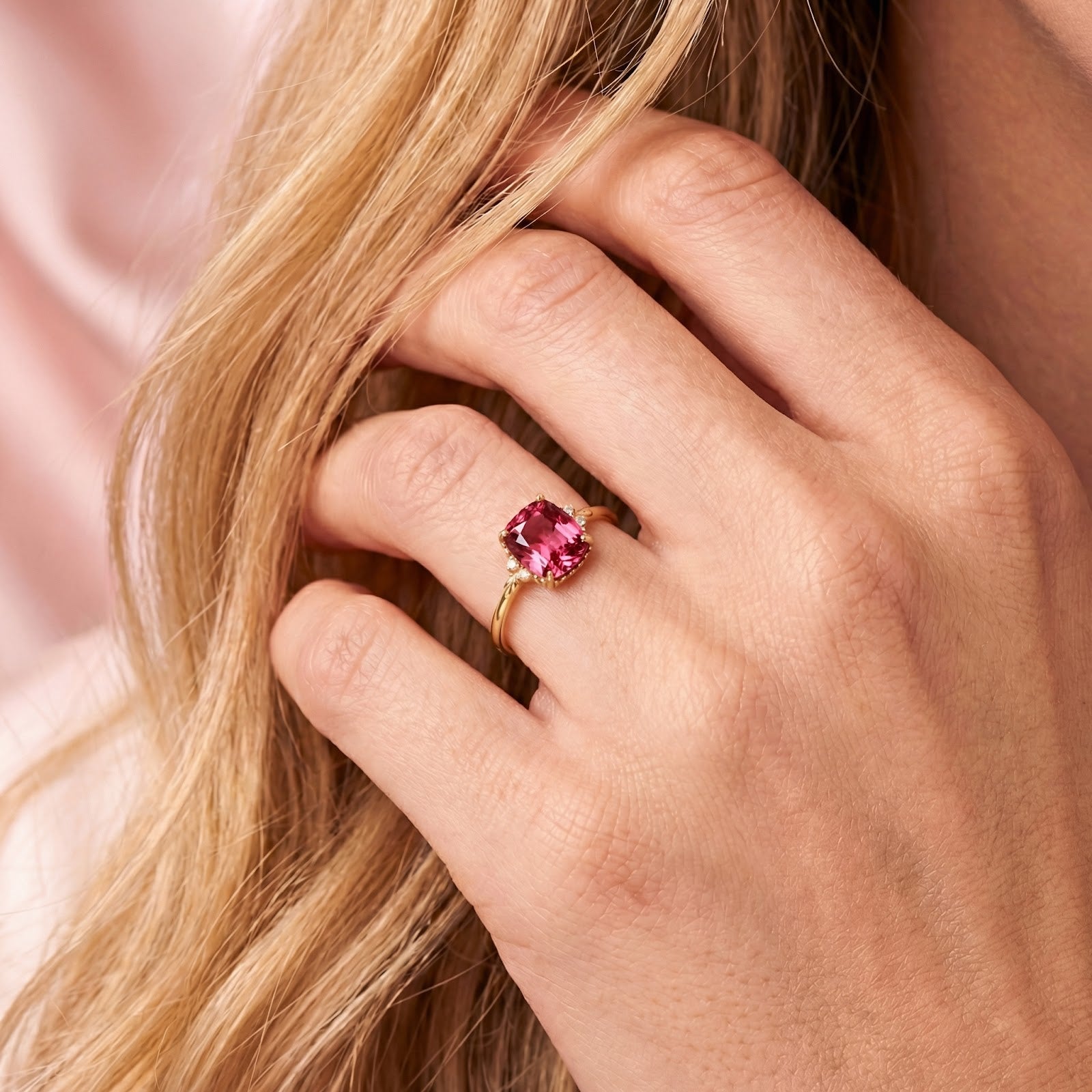 Model wearing the cushion cut simulated pink tourmaline gold vermeil ring on her finger.