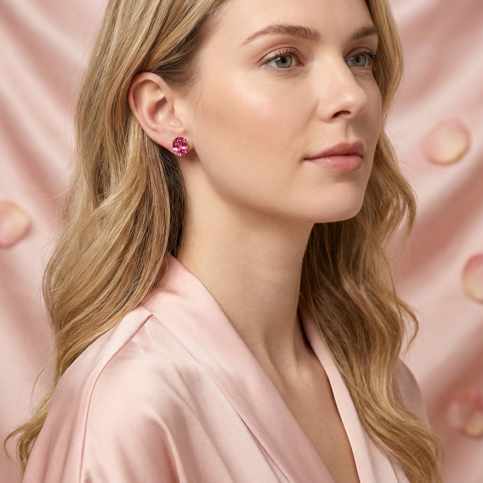 Model wearing oval cut simulated pink tourmaline sterling silver stud earrings with a pink silk robe.