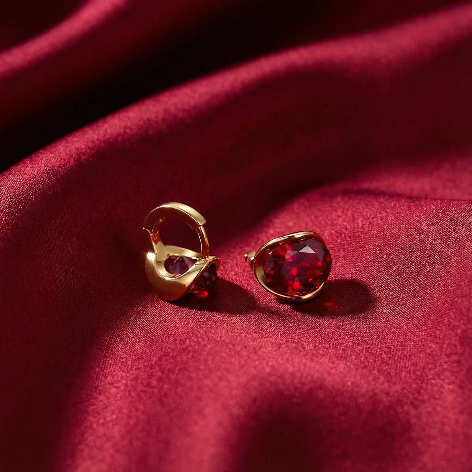 Macro shot showing the 18K gold vermeil setting and precision-cut simulated ruby on red satin.