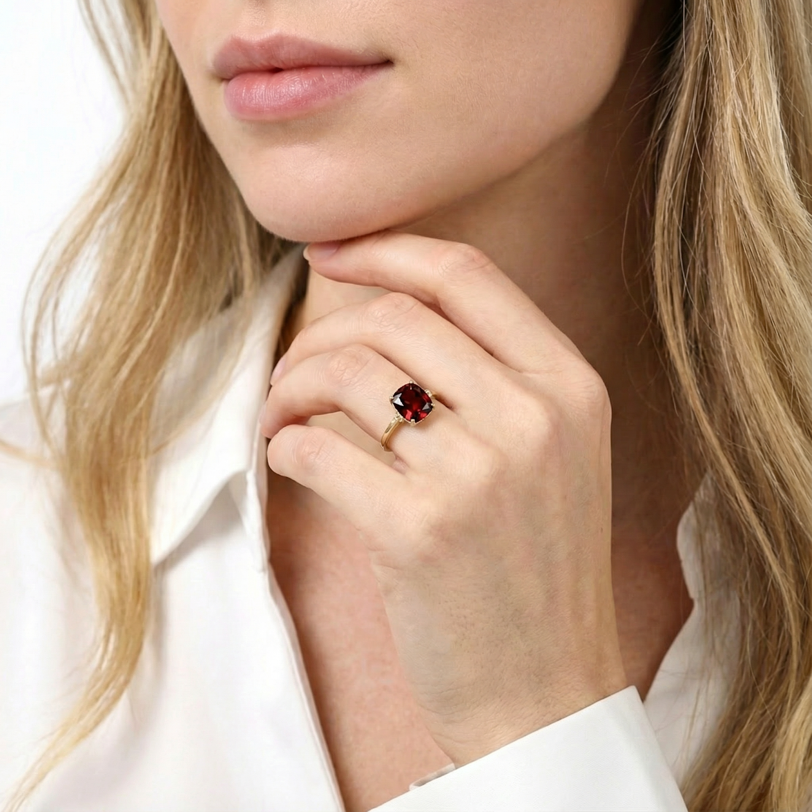 Model wearing the Valerine cushion cut simulated garnet ring in 18K gold vermeil on her ring finger.