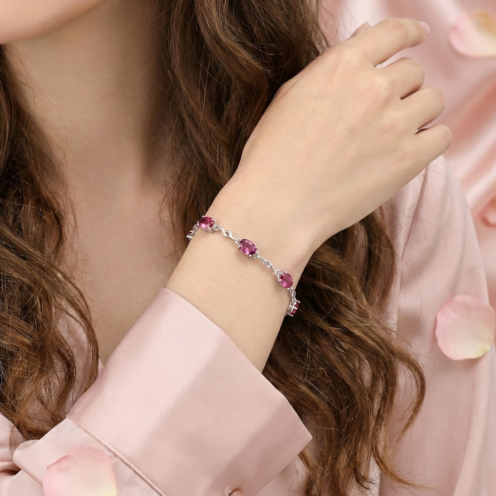 Thaliraea S925 sterling silver bracelet with oval pink tourmalines worn on a woman's wrist.