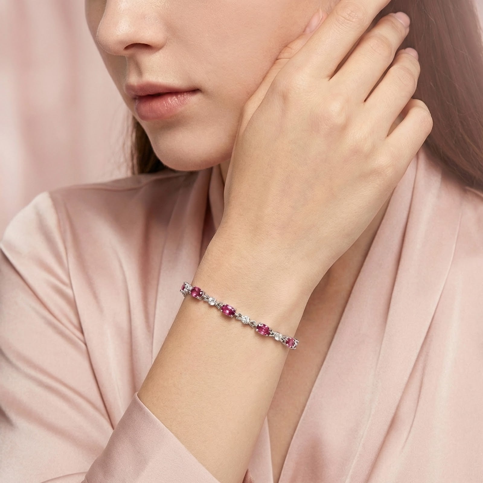 Model wearing the sterling silver Evantelle bracelet with oval-cut simulated pink tourmaline stones.