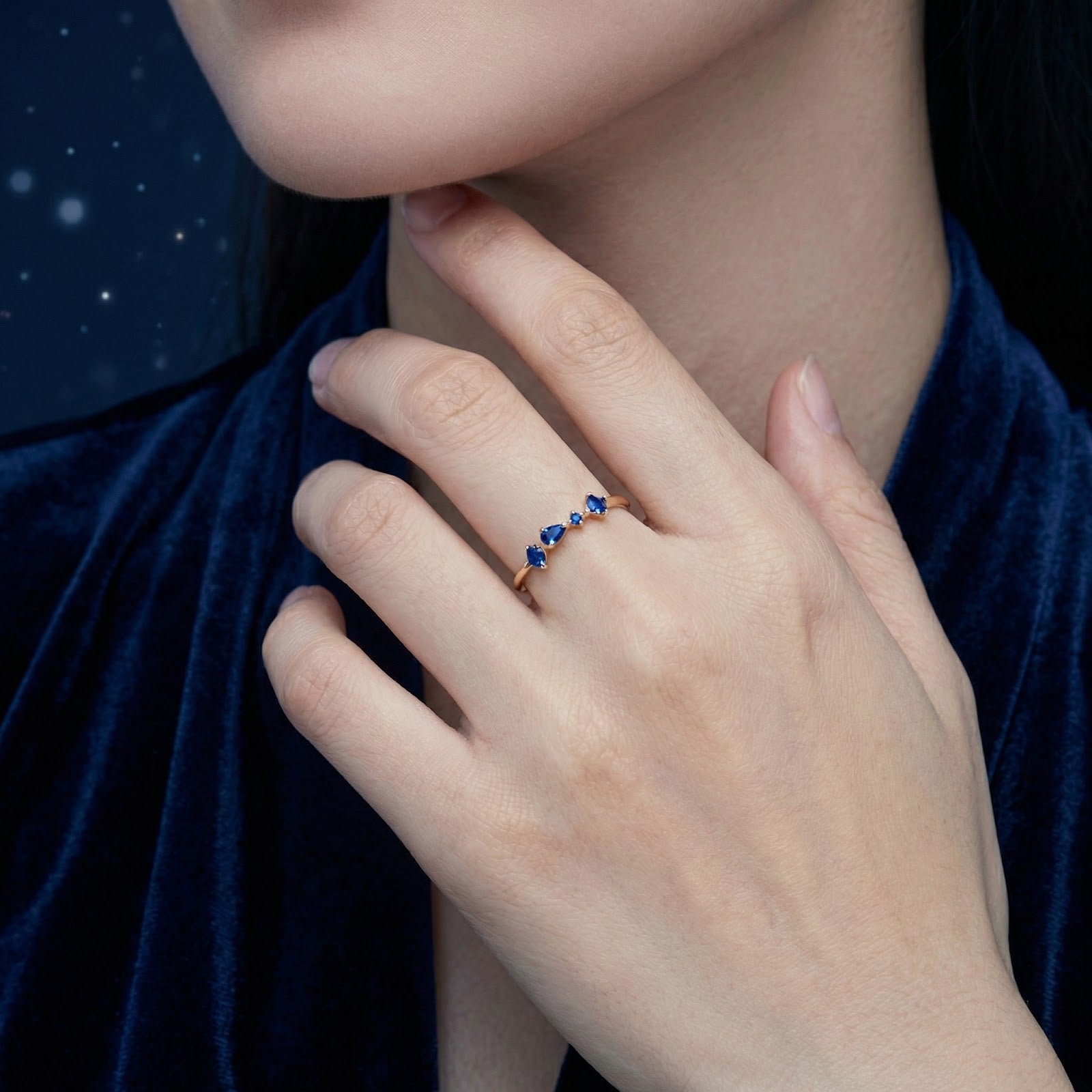 Model wearing the Nyara V-ring in 18K gold vermeil with simulated blue sapphires on her ring finger.