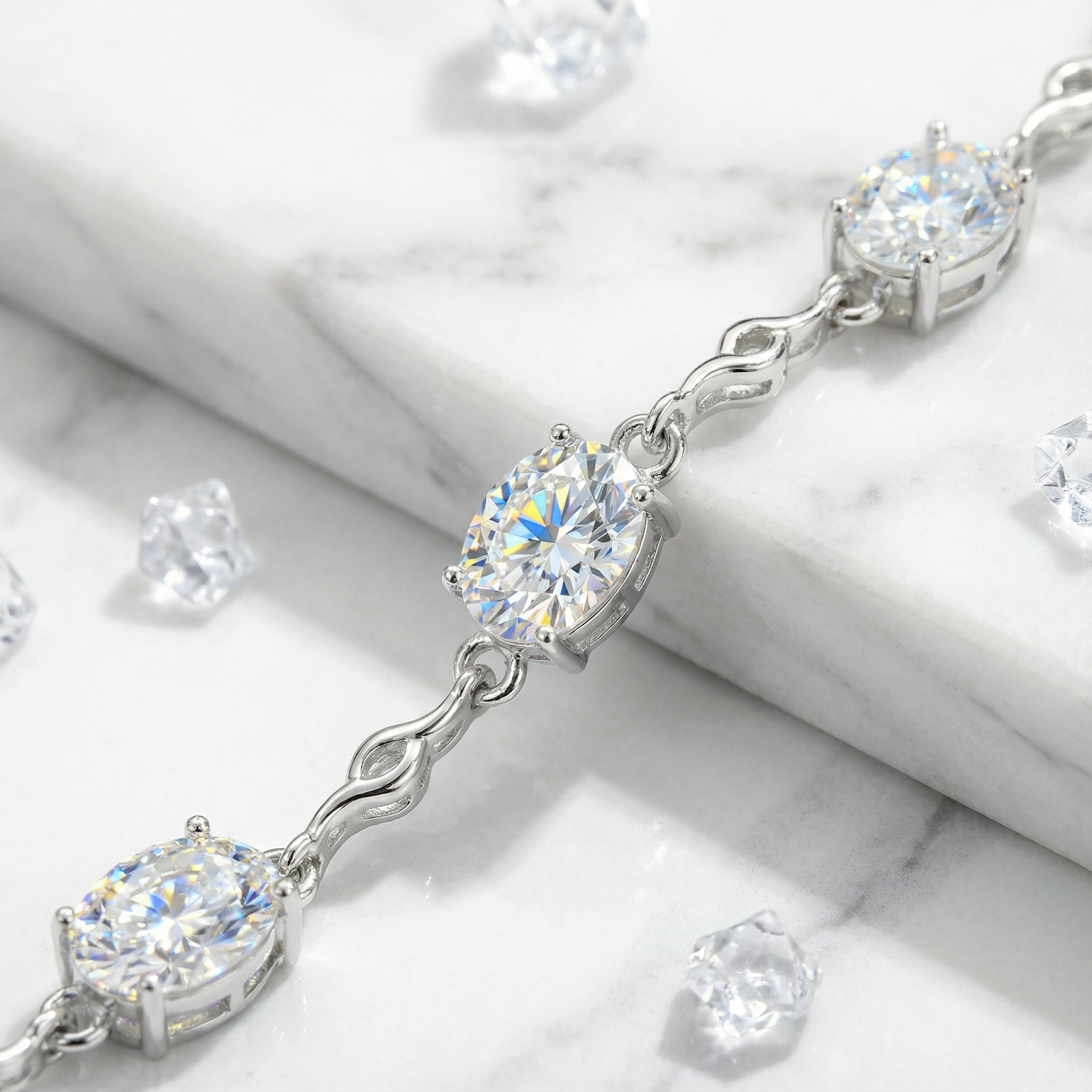 Close-up of oval-cut zirconia stones in a sterling silver station bracelet setting.