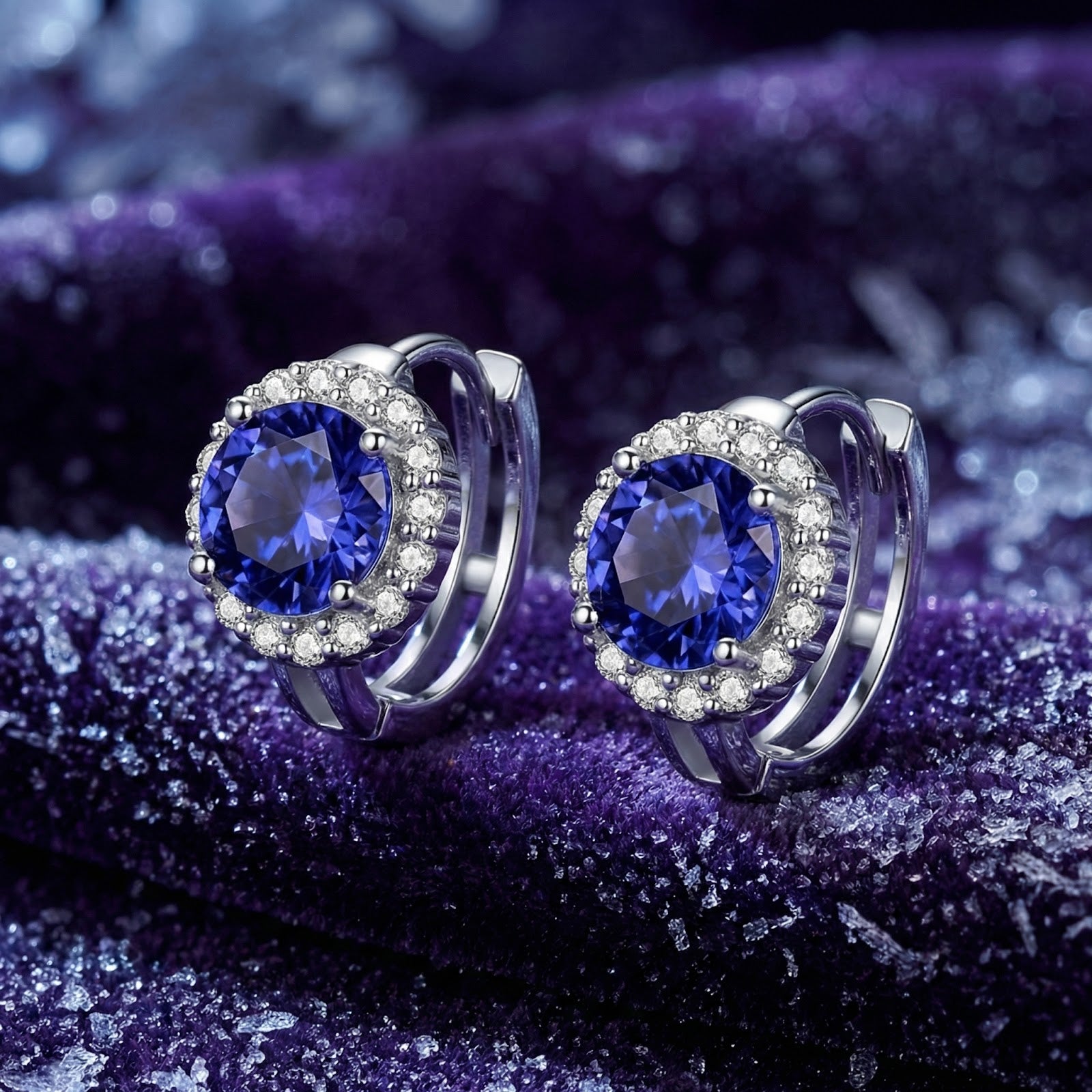 Side view of round blue-violet moissanite halo stud earrings in S925 sterling silver on a purple velvet background.