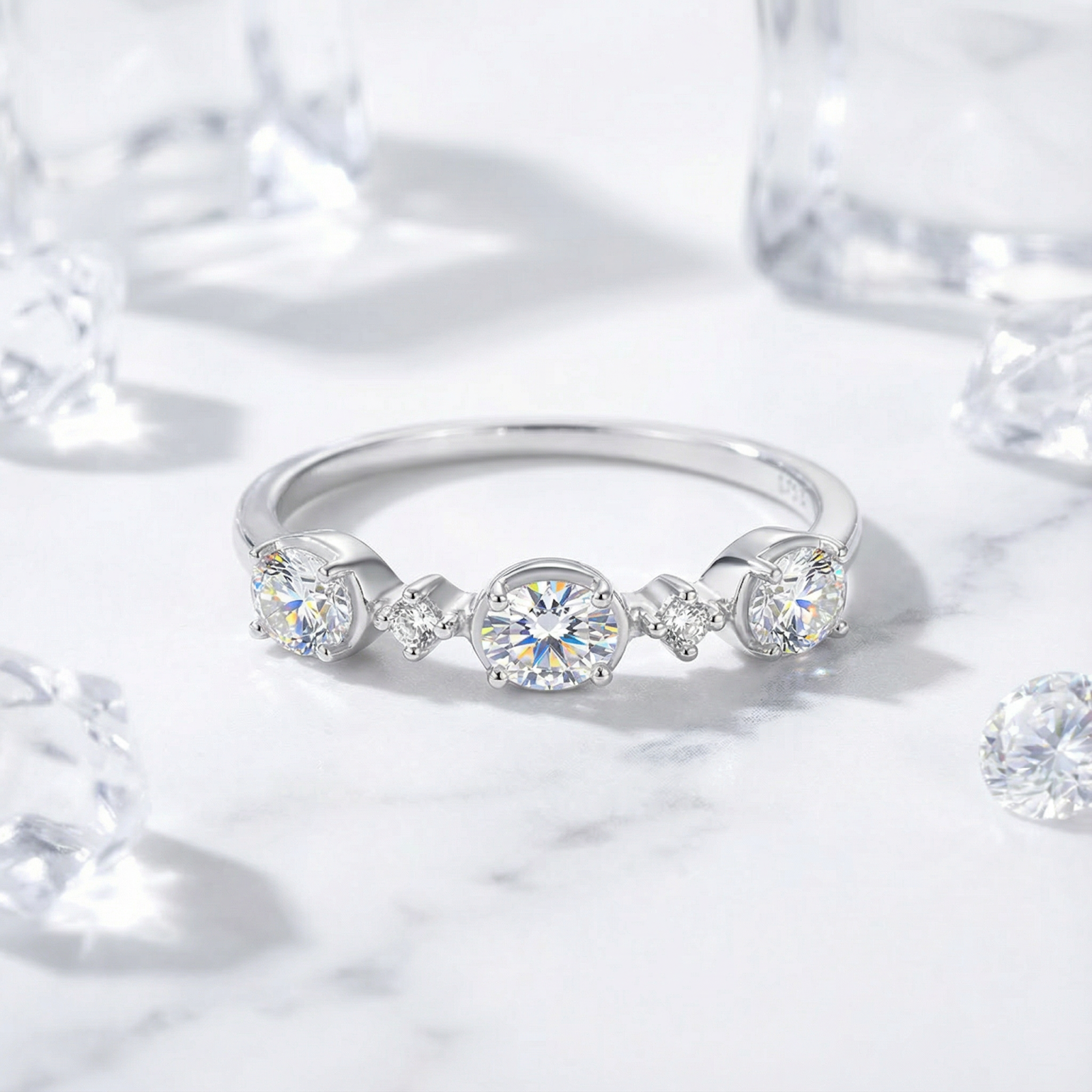 Elianne round cut zirconia ring in S925 sterling silver on a marble surface with decorative ice cubes.