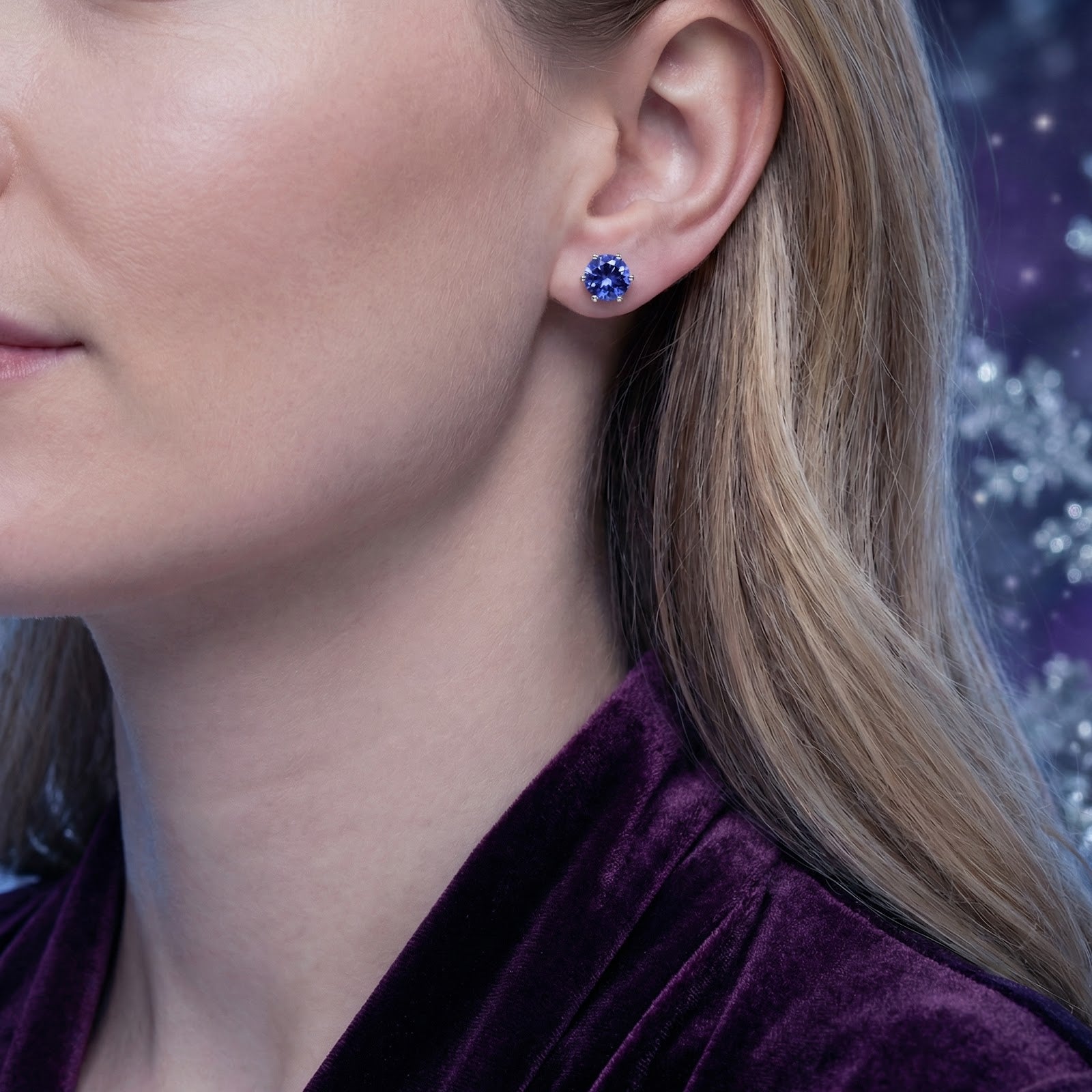 Round blue-violet simulated tanzanite stud earring in sterling silver worn by a model.