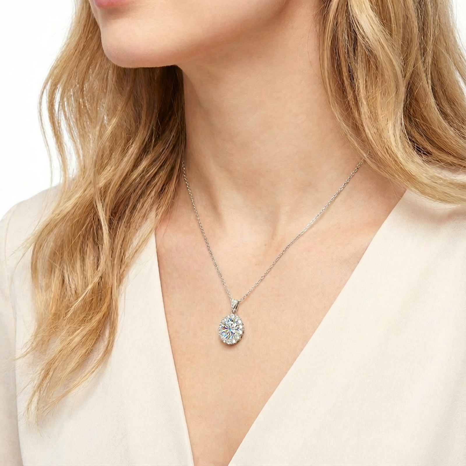 Side profile of a woman wearing an oval cut simulated diamond halo necklace in S925 silver.