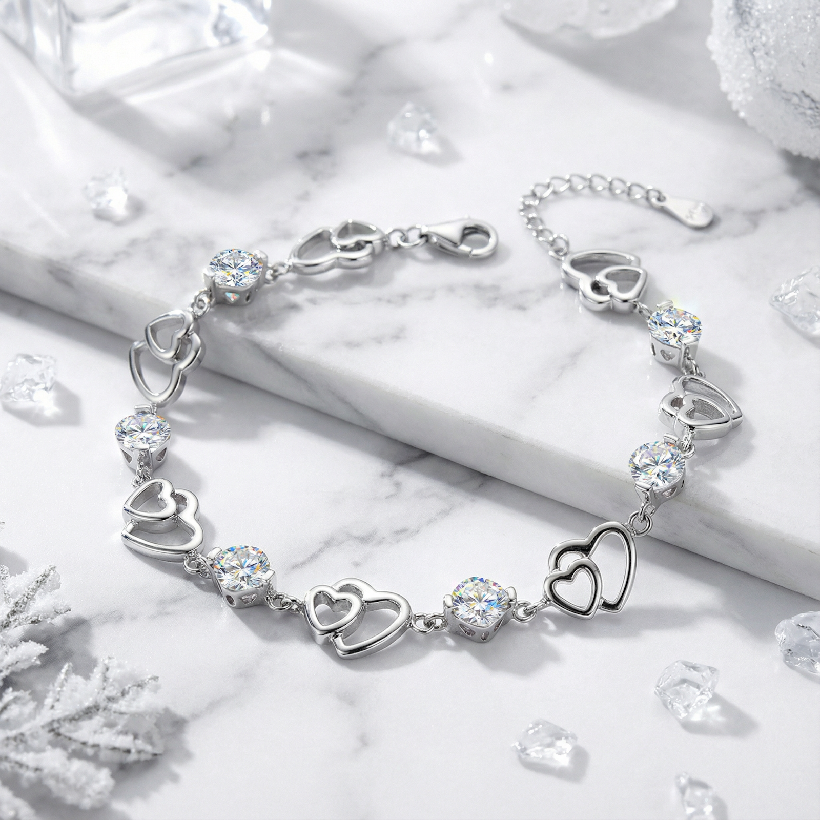 S925 sterling silver heart bracelet with round simulated diamonds on a marble surface with decorative crystals.