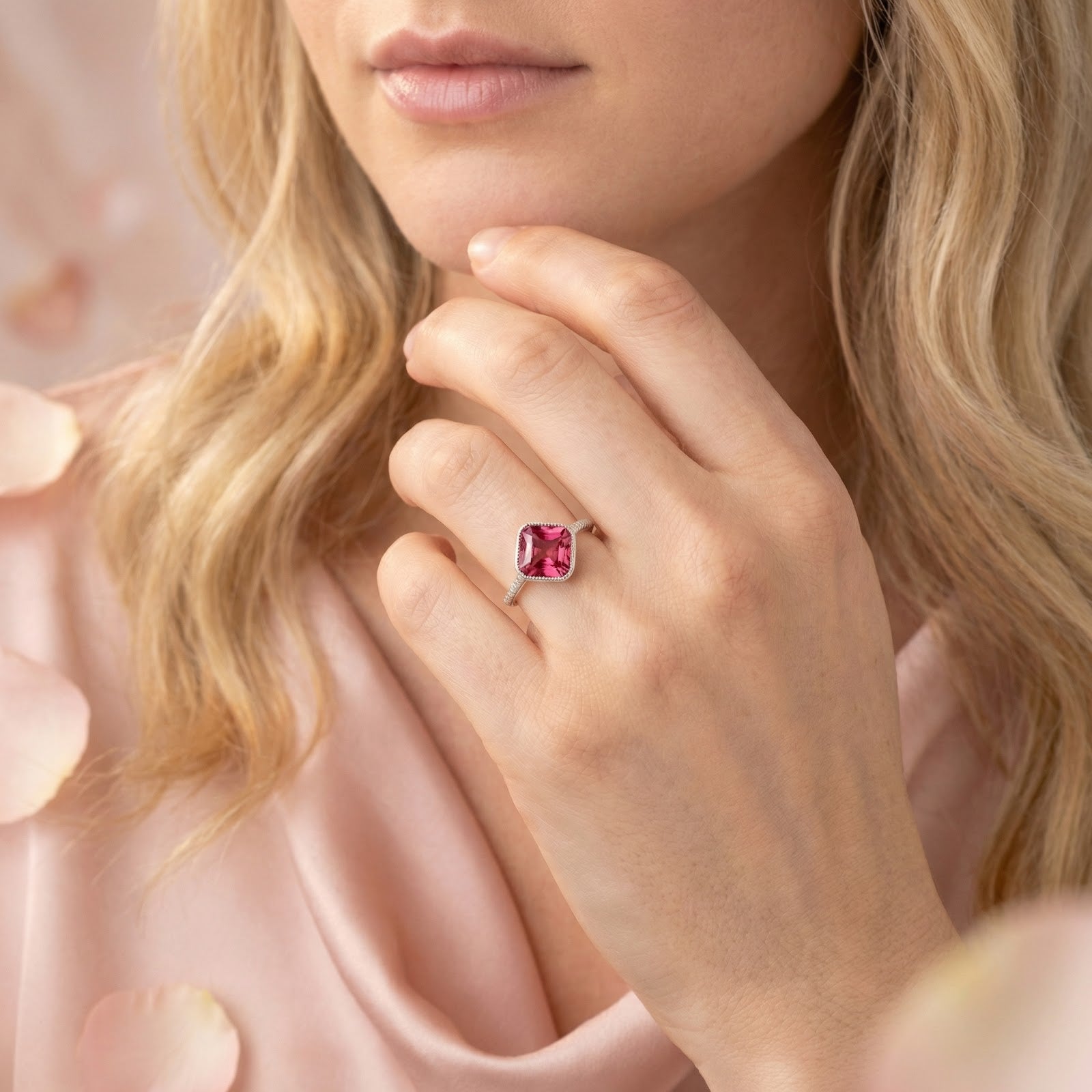 Woman wearing the Arisette pink tourmaline cushion ring in sterling silver with a pink silk dress.