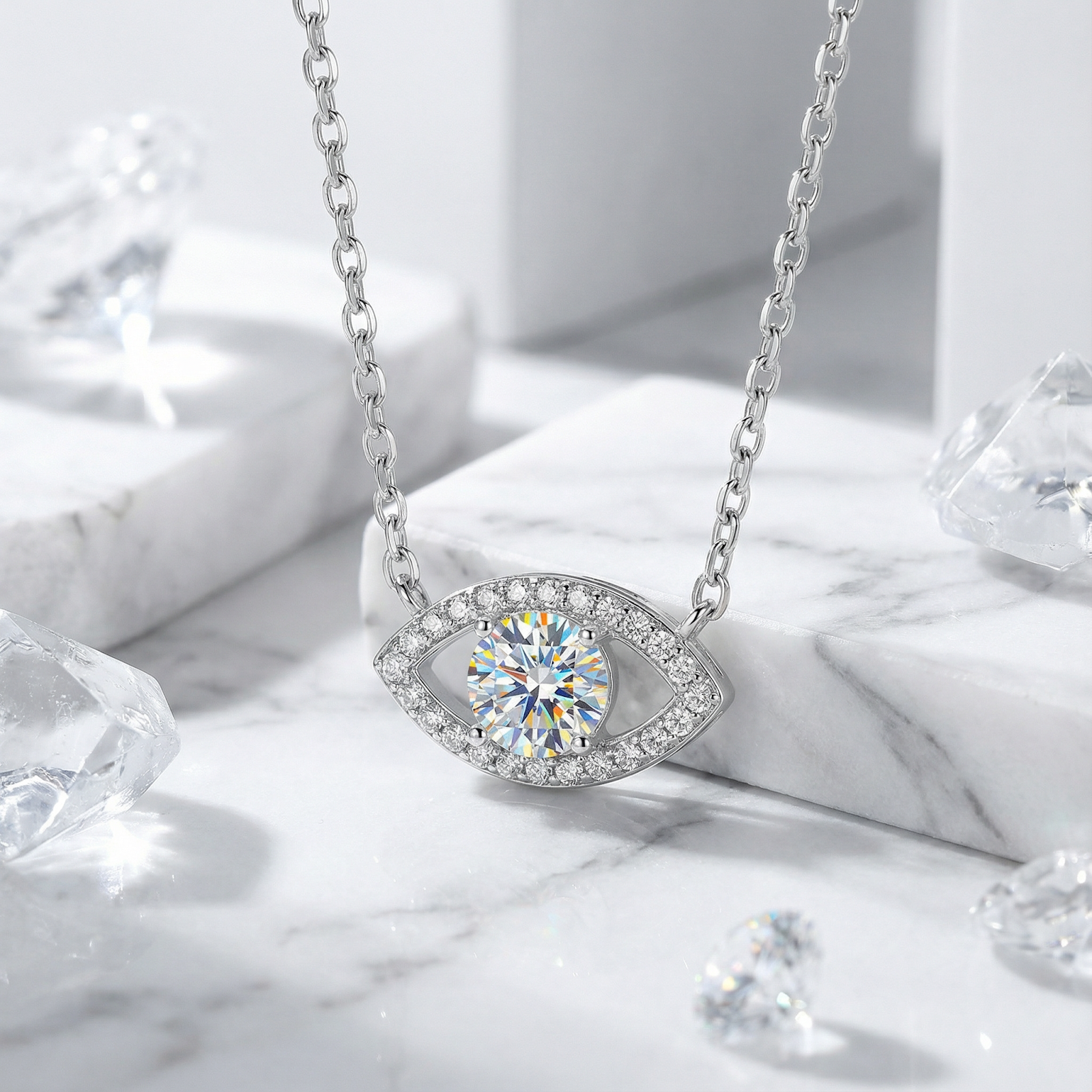 Front view of the silver Lyraea Eye necklace with a round cut moissanite pendant on marble.
