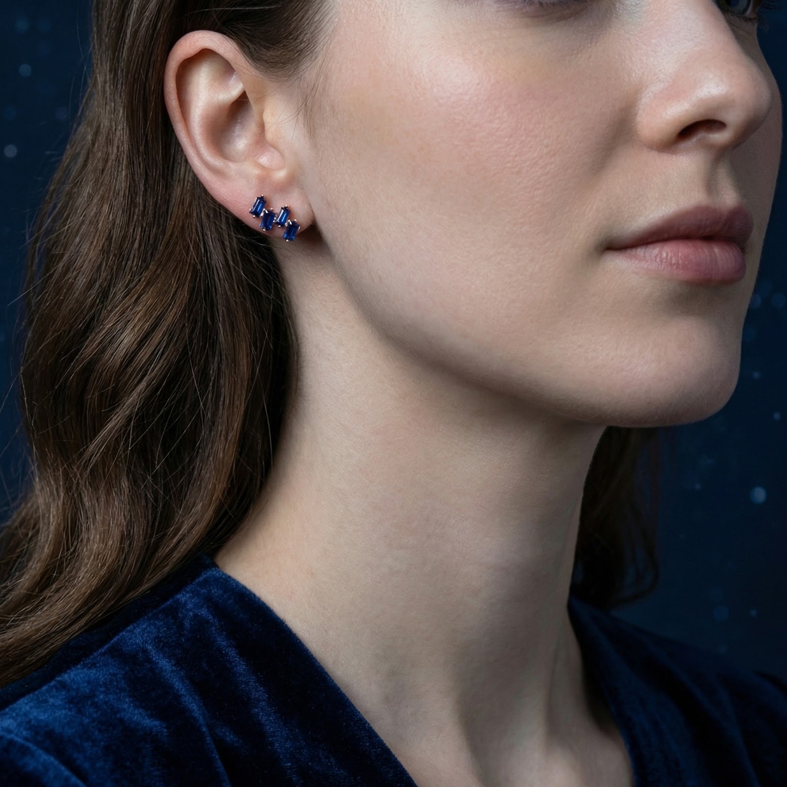 Model wearing the Vesperis 18K gold vermeil cluster earring with September birthstone simulated sapphires.