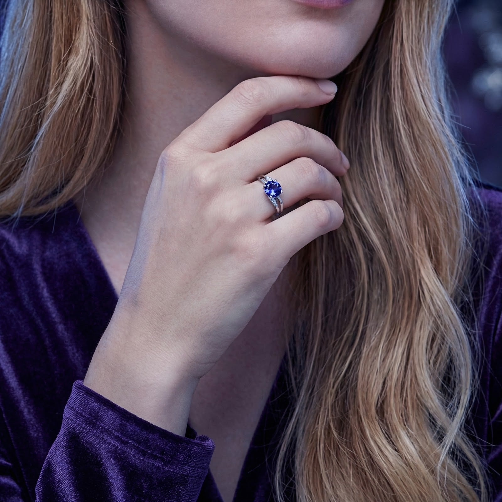 Model wearing the S925 sterling silver crossover ring with a round-cut simulated tanzanite.