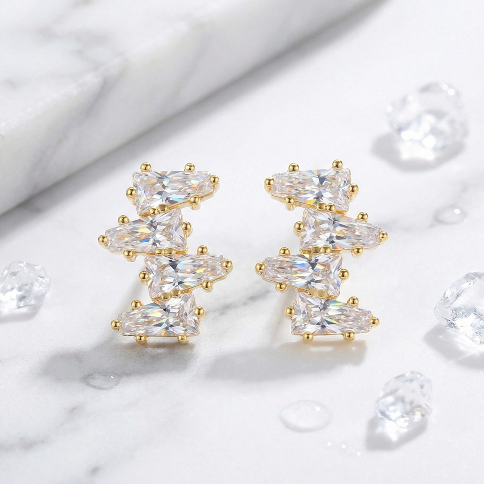 Detail view of 18K gold vermeil cluster earrings with precision-cut tapered baguette zirconia stones.
