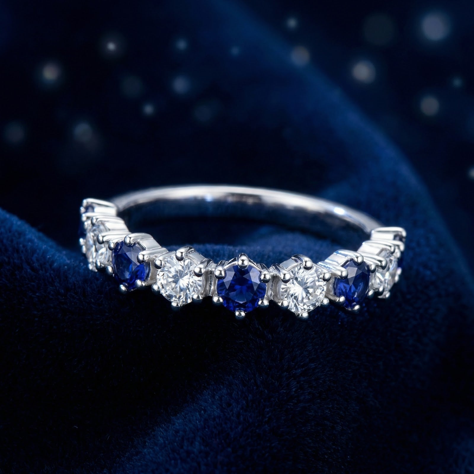 Macro view of the Thalissara S925 sterling silver row ring with alternating round blue and white stones.