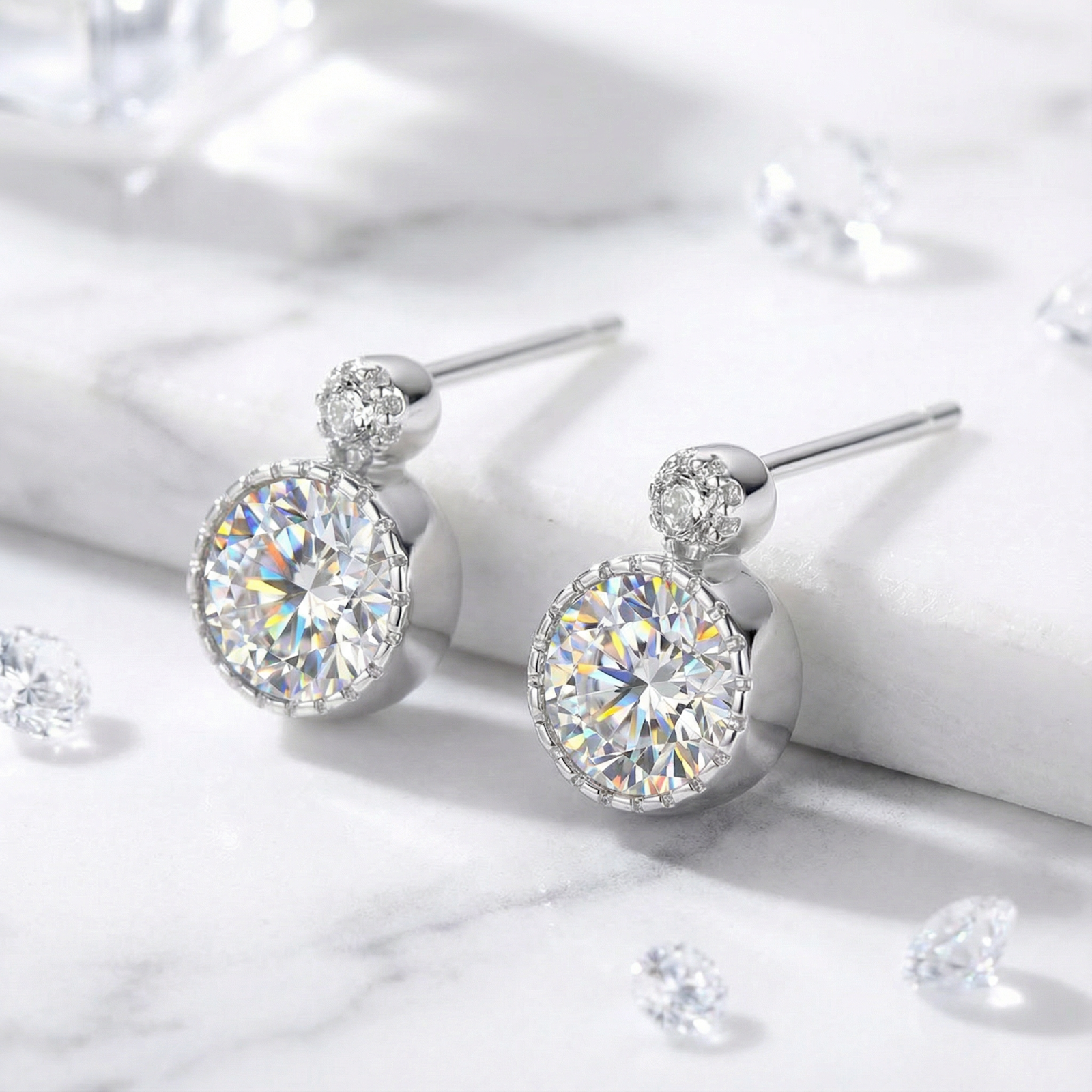 Round cut zirconia stud earrings in S925 sterling silver on a marble surface with loose stones.
