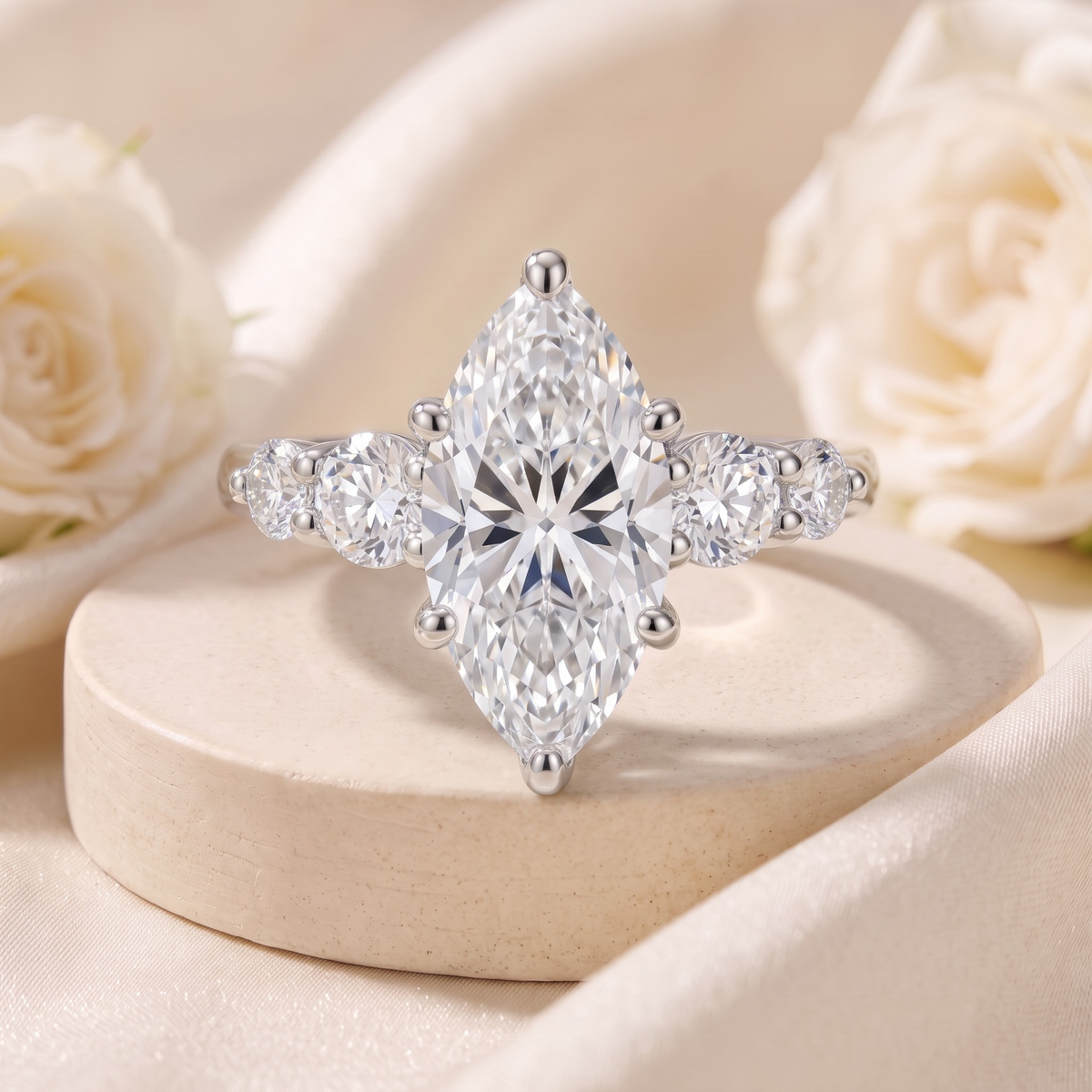 Marquise-cut moissanite ring in silver with round side stones, front product view.