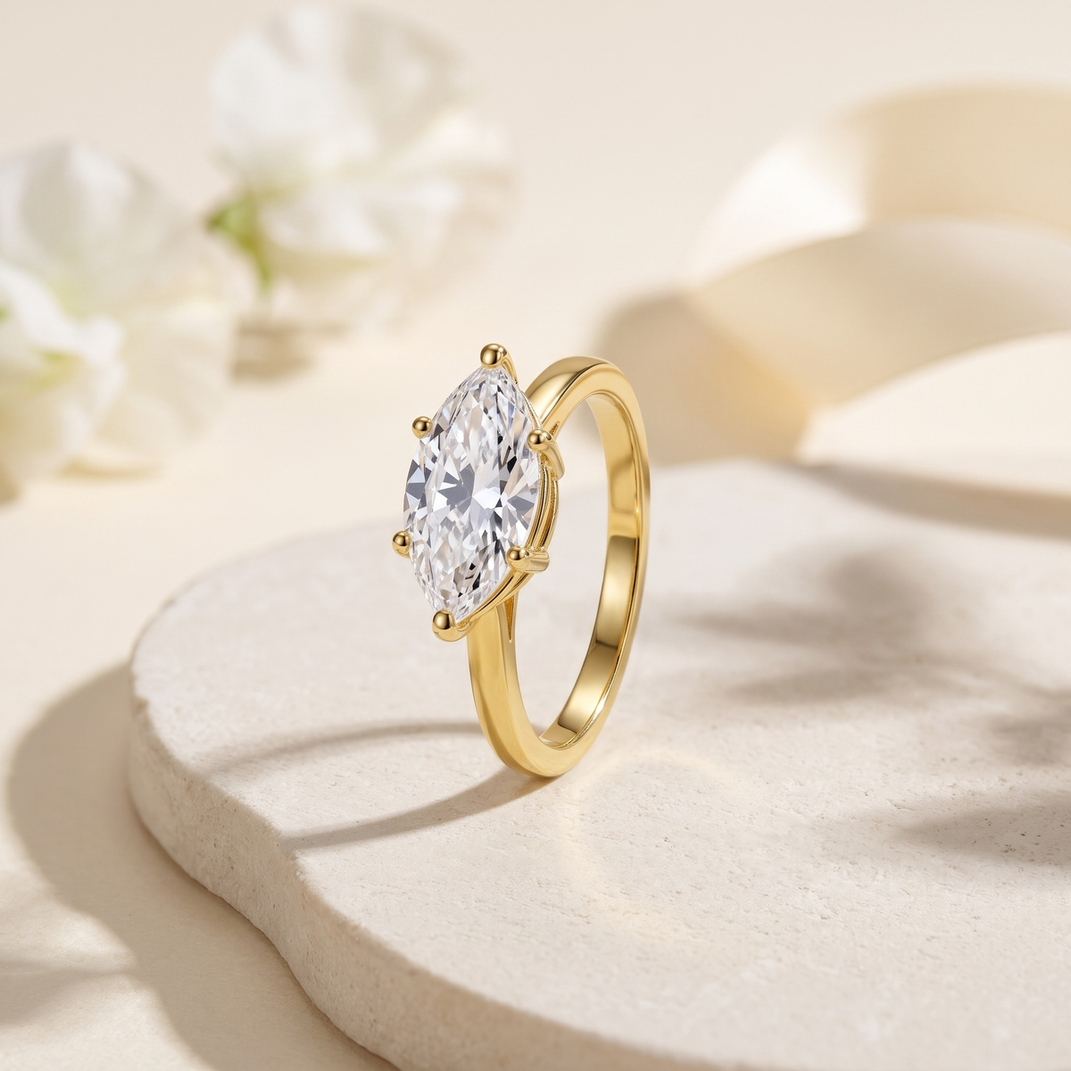 1CT marquise moissanite solitaire in yellow gold, isolated product view