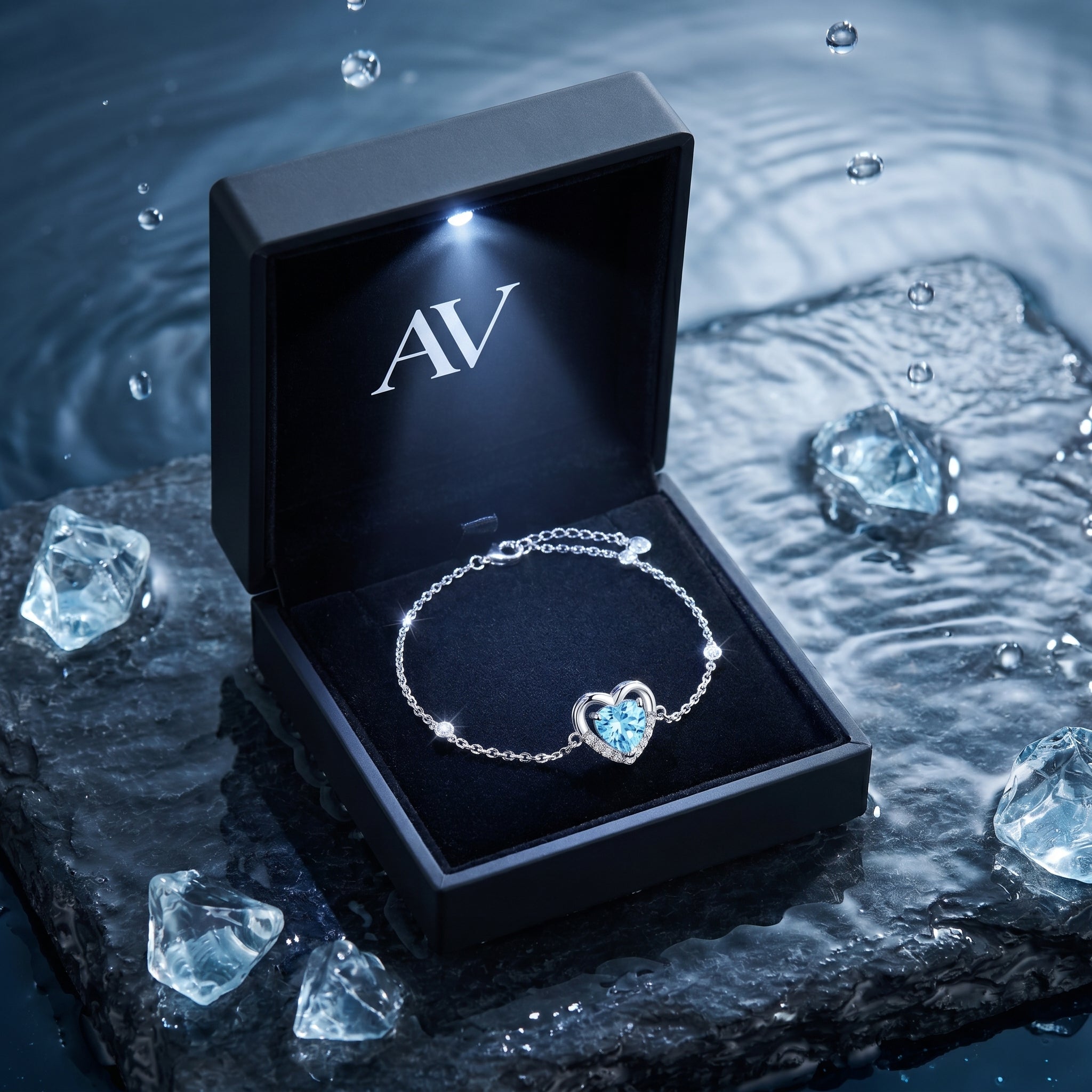 Heart cut aquamarine platinum bracelet inside a black lighted gift box on a wet stone background.