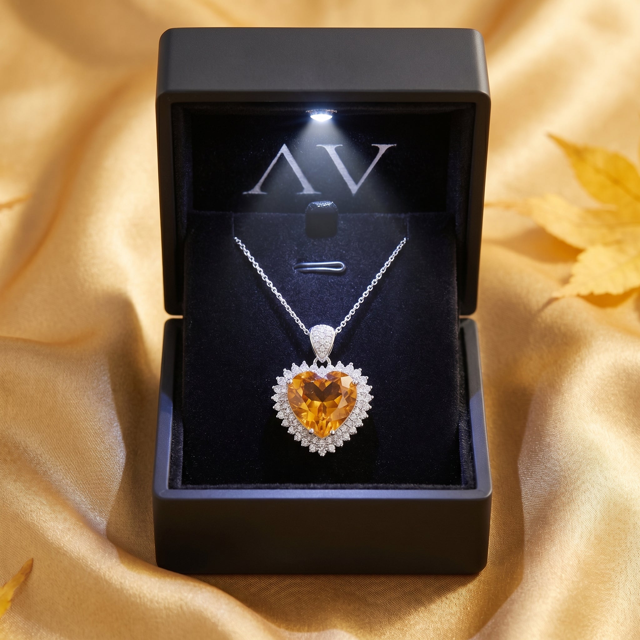 Heart cut citrine necklace in silver, presented in a black LED-lit gift box on golden silk.