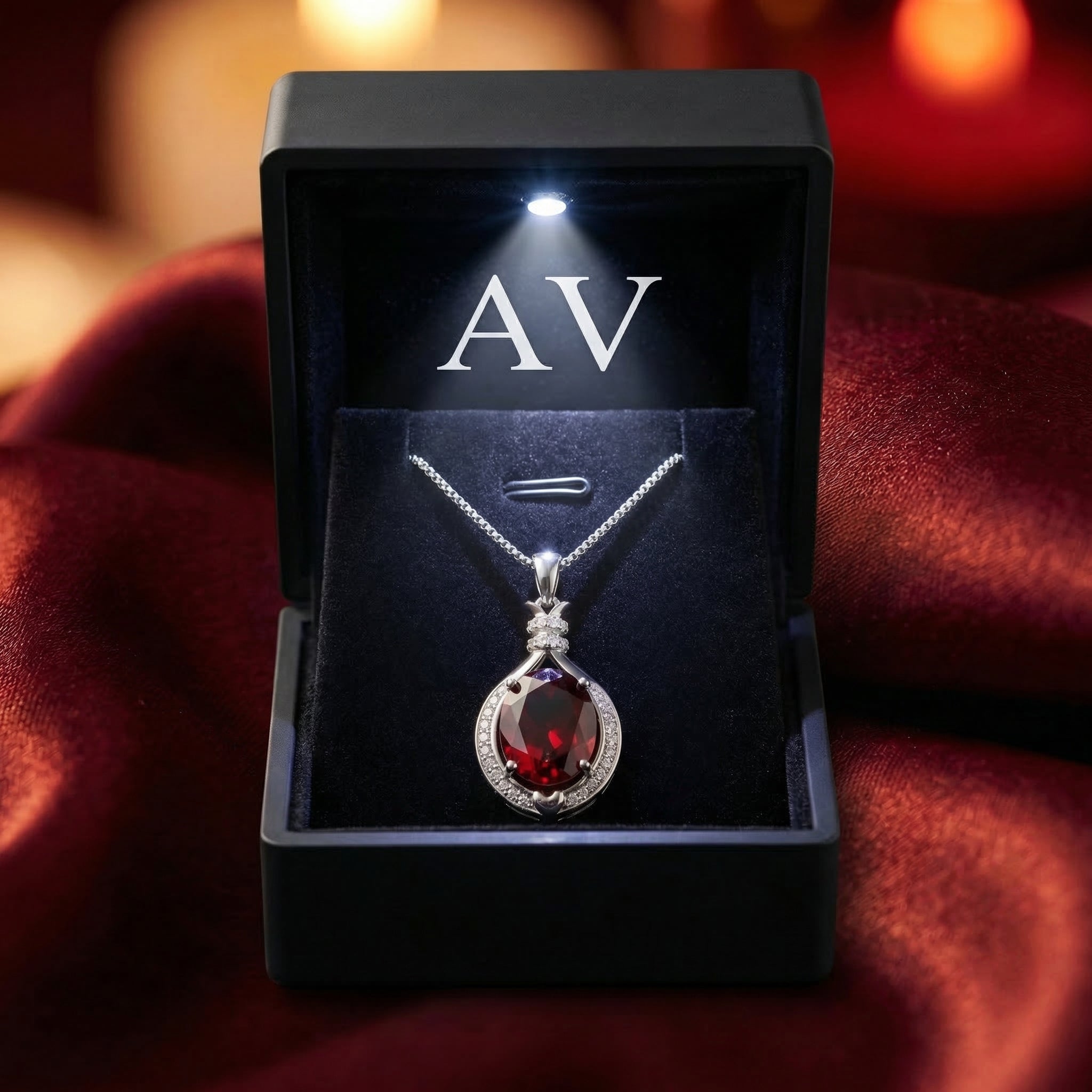 Oval natural garnet necklace in a premium black LED-lighted gift box on red silk.