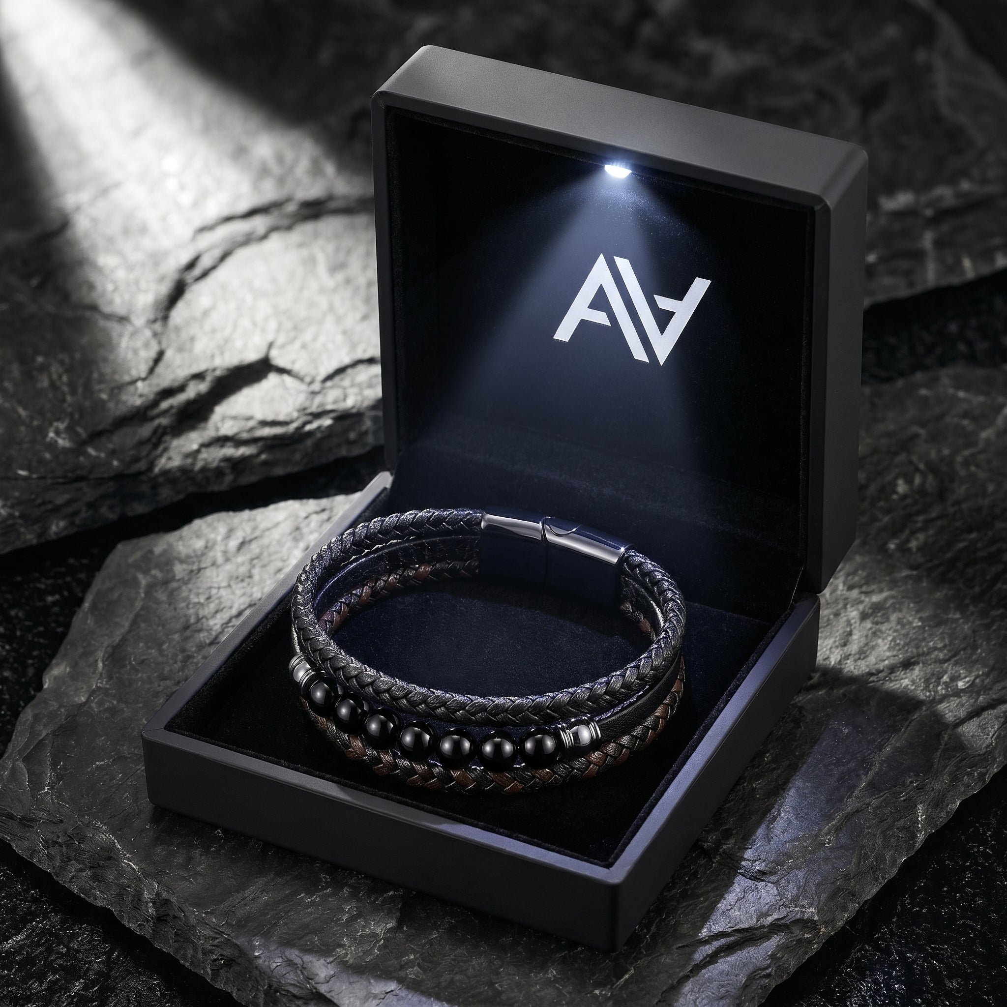 Men's black leather bracelet with black beads inside a premium black gift box with an integrated LED light.