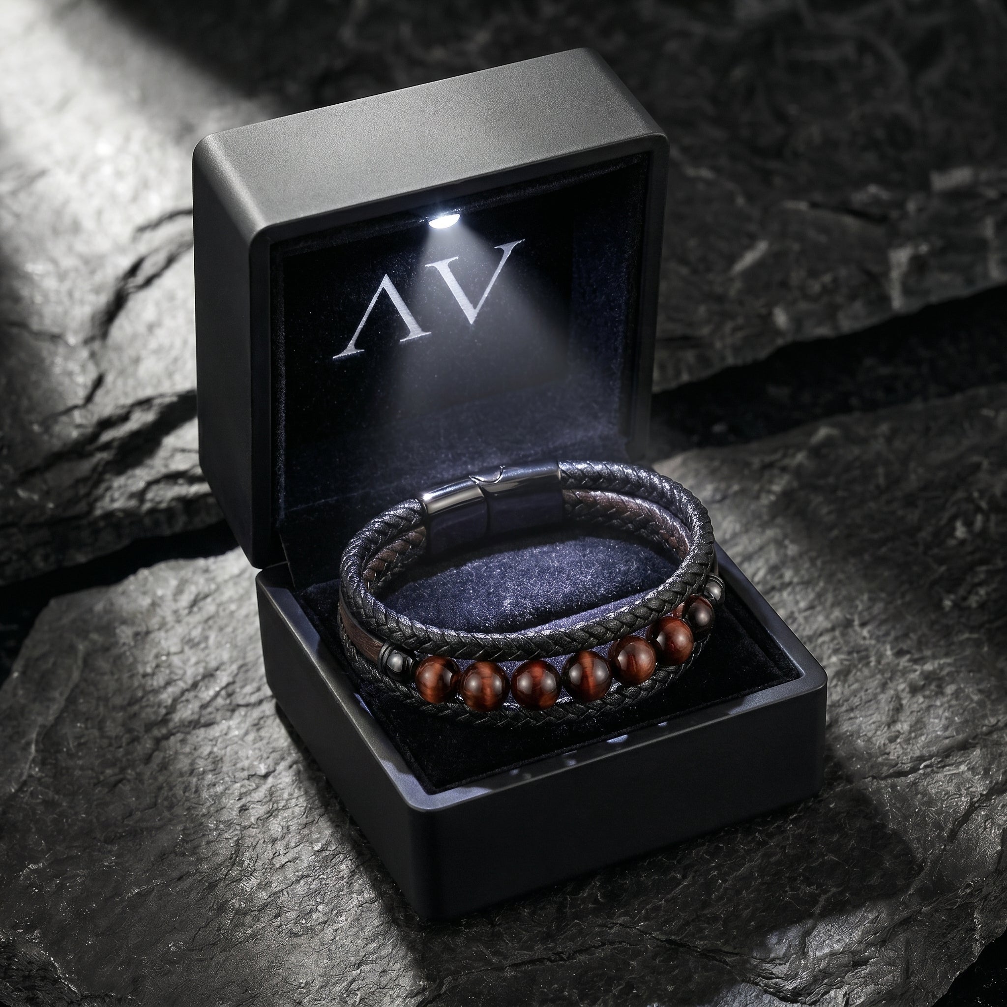 The Maverick leather bracelet with red tiger's eye beads inside a black LED-lit jewelry presentation box.