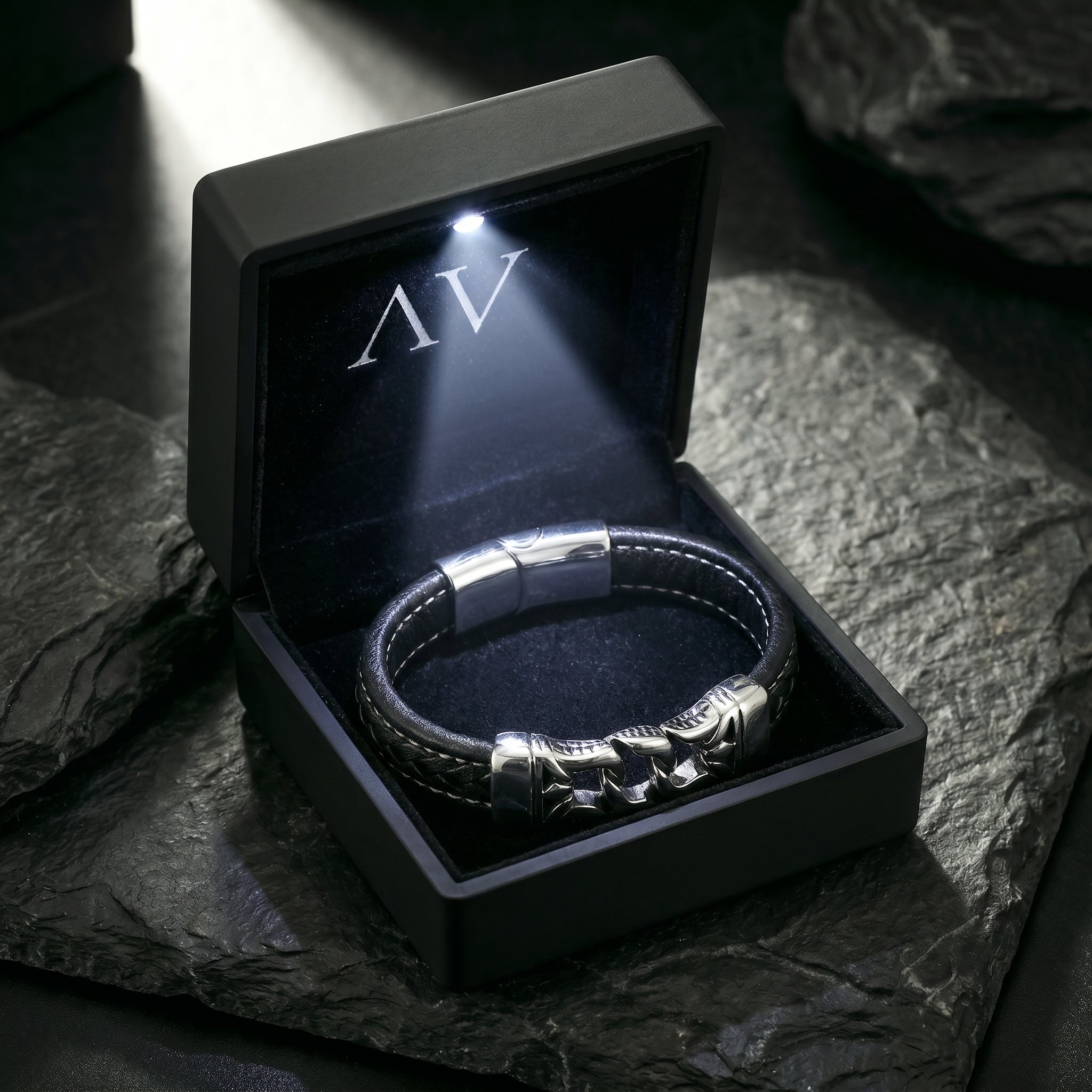 Black leather Nexus Bracelet with silver steel centerpiece in a premium LED-lit black jewelry gift box.