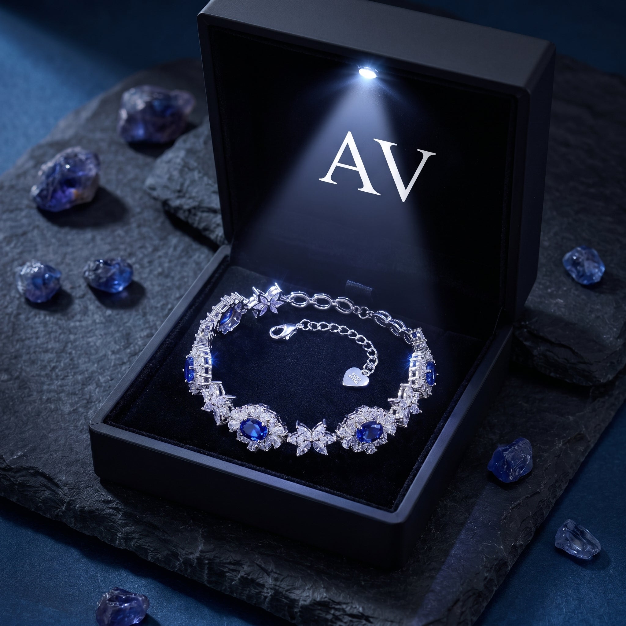Natural tanzanite floral tennis bracelet in white gold inside a black lighted presentation box.