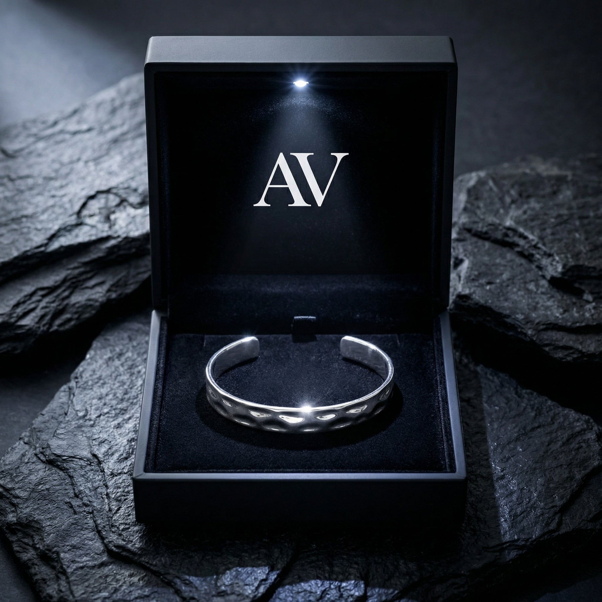 Silver hammered stainless steel cuff bangle presented in a black LED-lit gift box.