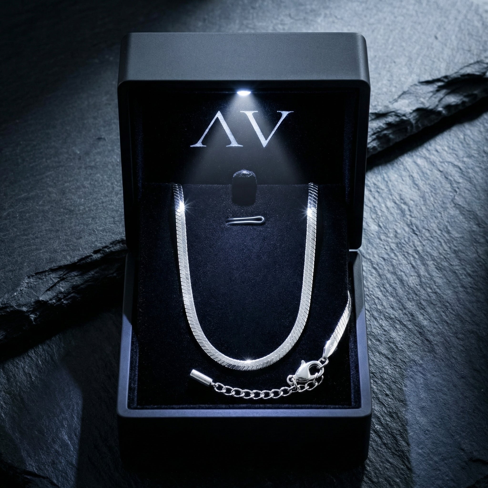 Silver stainless steel octagon link bracelet presented in a premium black lighted jewelry box.