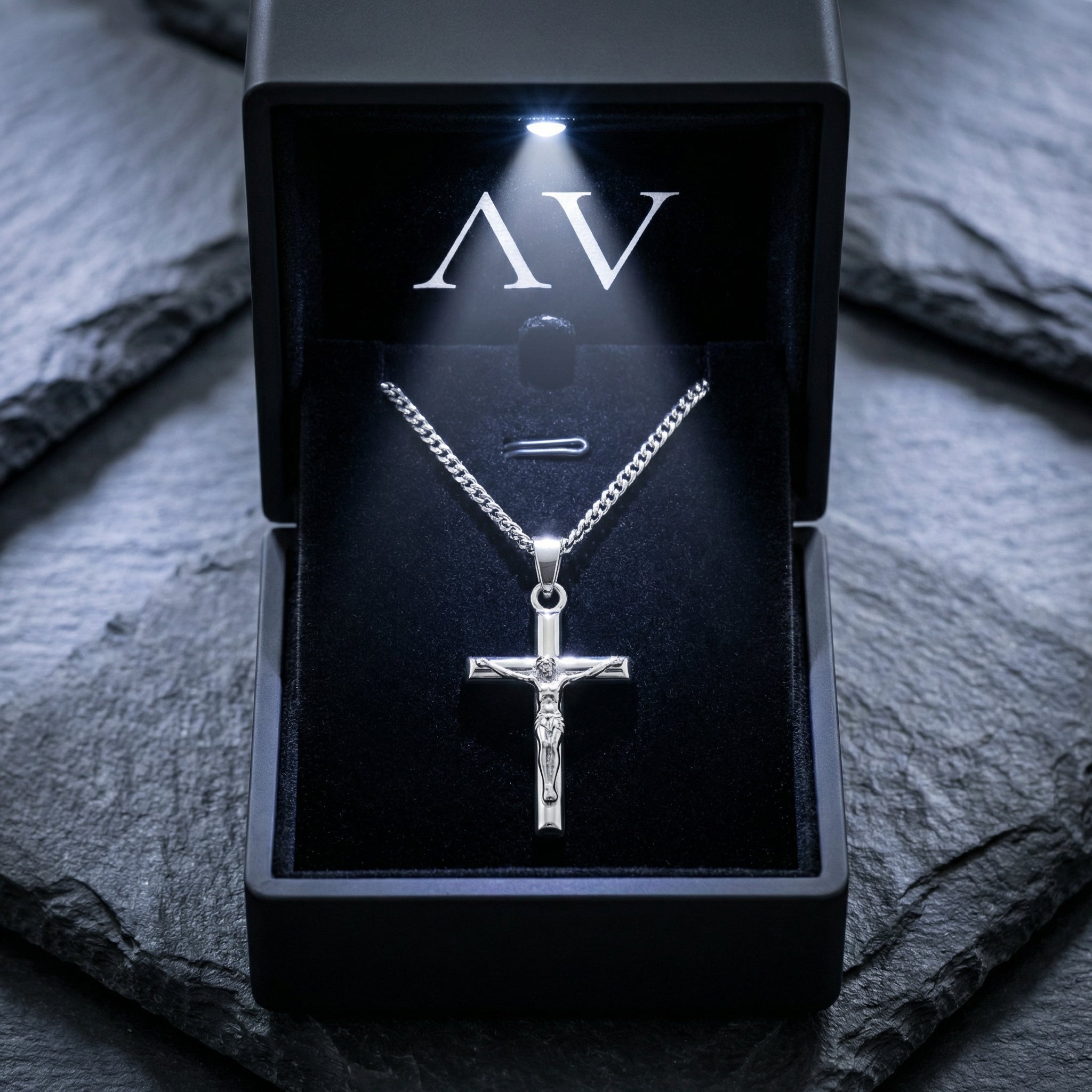 Silver stainless steel crucifix pendant necklace presented in a black LED-lit jewelry gift box.