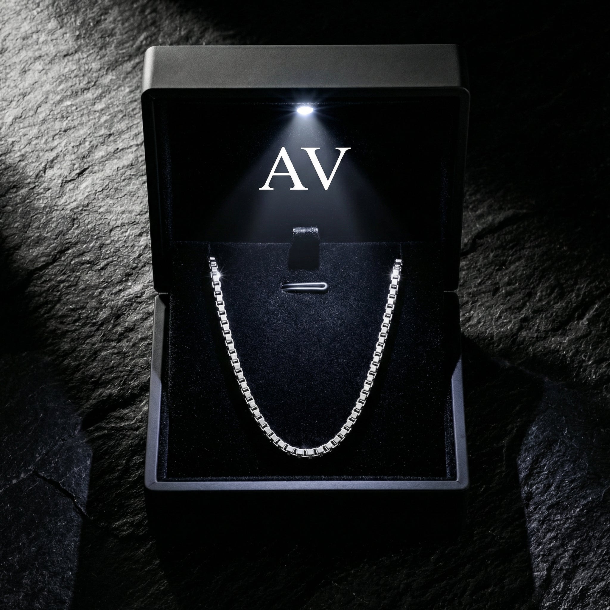 Silver stainless steel boxer chain presented in a premium black lighted jewelry gift box.