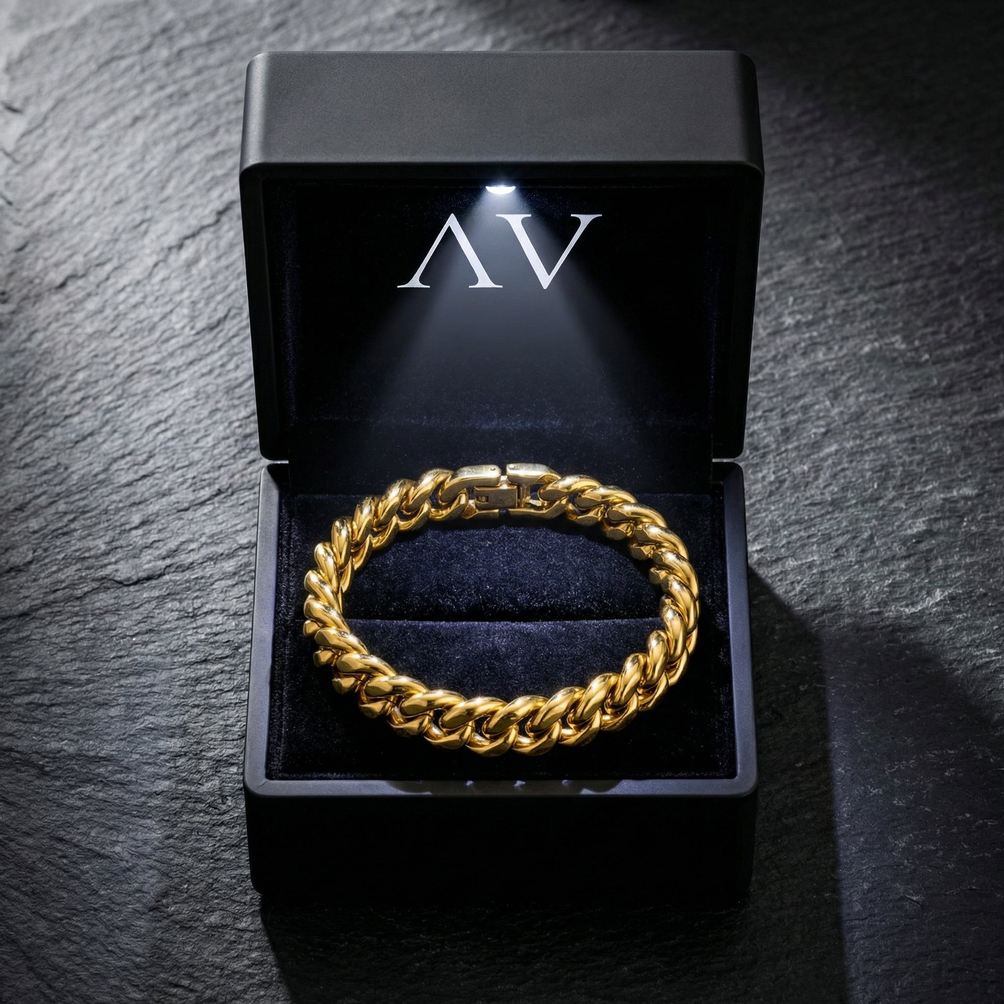 Gold Cuban link bracelet displayed in a premium black LED-lit jewelry presentation box.